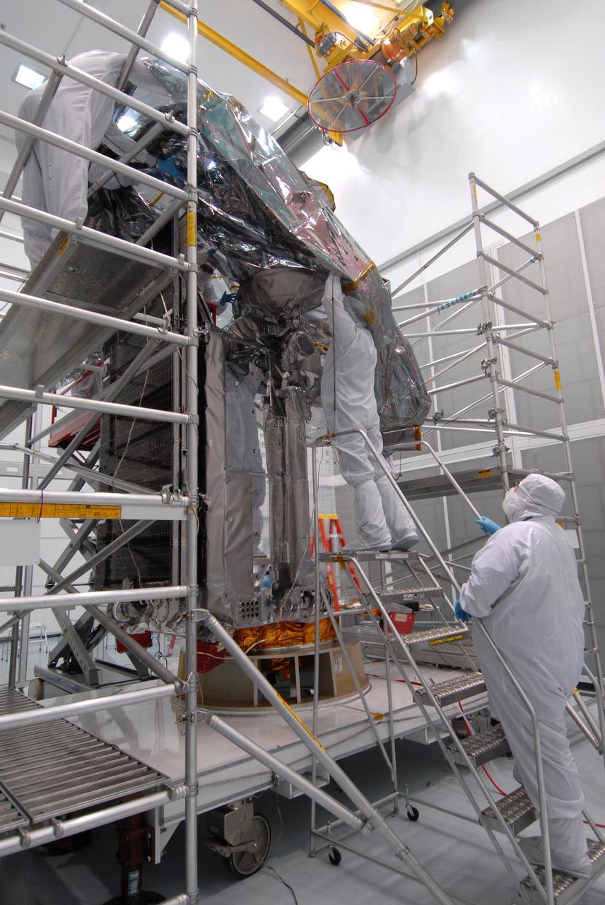 CAPE CANAVERAL, Fla. – At Astrotech Space Operations in Titusville, Fla.,  technicians begin placing the protective bag around the Lunar Reconnaissance Orbiter, or LRO, before it is mated with NASA's Lunar CRater Observation and Sensing Satellite, known as LCROSS, spacecraft.  The satellite's primary mission is to search for water ice on the moon in a permanently shadowed crater near one of the lunar poles. LCROSS is a low-cost, accelerated-development, companion mission to NASA's Lunar Reconnaissance Orbiter, or LRO. LCROSS and LRO are the first missions in NASA's plan to return humans to the moon and begin establishing a lunar outpost by 2020. Launch is targeted for no earlier than June 2 from Cape Canaveral Air Force Station in Florida. Photo credit: NASA/Jack Pfaller