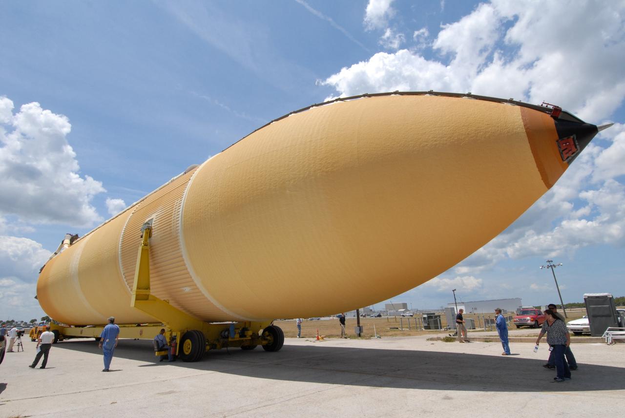 CAPE CANAVERAL, Fla. – The external fuel tank, ET- 132, designated for use with space shuttle Discovery on the STS-128 mission is moved away from the turn basin, heading for the Vehicle Assembly Building (at left) at NASA's Kennedy Space Center in Florida for checkout in a high bay. On the STS-128 mission, Discovery will carry science and storage racks to the International Space Station. Launch of Discovery is targeted for Aug. 6. Photo credit: NASA/Jack Pfaller