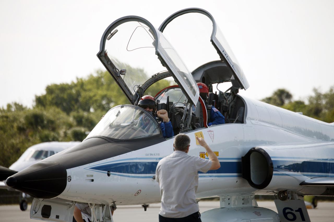 CAPE CANAVERAL, Fla. – STS-125 Commander Scott Altman (in front) and Mission Specialist John Grunsfeld arrive at the Shuttle Landing Facility at NASA's Kennedy Space Center in Florida aboard a T-38 training jet to get ready for launch aboard space shuttle Atlantis on May 11.  Altman will be making his fourth shuttle flight; Grunsfeld, his fifth. Atlantis' crew will service NASA's Hubble Space Telescope for the fifth and final time. The flight will include five spacewalks during which astronauts will refurbish and upgrade the telescope with state-of-the-art science instruments. As a result, Hubble's capabilities will be expanded and its operational lifespan extended through at least 2014. Photo credit: NASA/Jim Grossmann
