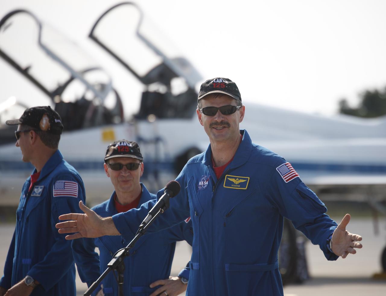 CAPE CANAVERAL, Fla. – At the Shuttle Landing Facility at NASA's Kennedy Space Center in Florida, STS-125 Commander Scott Altman (at microphone) addresses the media on hand to welcome the STS-125 crew to Florida. The crew arrived aboard T-38 training jets to get ready for launch aboard space shuttle Atlantis on May 11.  From left are also Mission Specialist Michael Good and Pilot Gregory C. Johnson. Atlantis' crew will service NASA's Hubble Space Telescope for the fifth and final time. The flight will include five spacewalks during which astronauts will refurbish and upgrade the telescope with state-of-the-art science instruments. As a result, Hubble's capabilities will be expanded and its operational lifespan extended through at least 2014. Photo credit: NASA/Jim Grossmann