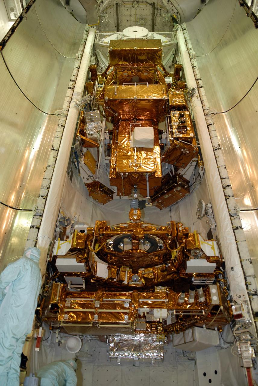 CAPE CANAVERAL, Fla. – On Launch Pad 39A at NASA's Kennedy Space Center in Florida, workers prepare to close the doors of space shuttle Atlantis' payload bay that is filled with hardware for the STS-125 mission to service NASA's Hubble Space Telescope. At the bottom are the Flight Support System with the Soft Capture mechanism and Multi-Use Lightweight Equipment Carrier with the Science Instrument Command and Data Handling Unit, or SIC&DH. At center is the Orbital Replacement Unit Carrier with the Cosmic Origins Spectrograph, or COS, and an IMAX 3D camera. At top is the Super Lightweight Interchangeable Carrier with the Wide Field Camera 3. Atlantis' crew will service NASA's Hubble Space Telescope for the fifth and final time. The flight will include five spacewalks during which astronauts will refurbish and upgrade the telescope with state-of-the-art science instruments. As a result, Hubble's capabilities will be expanded and its operational lifespan extended through at least 2014. Launch is scheduled for 2:01 p.m. EDT on May 11. Photo credit: NASA/Kim Shiflett