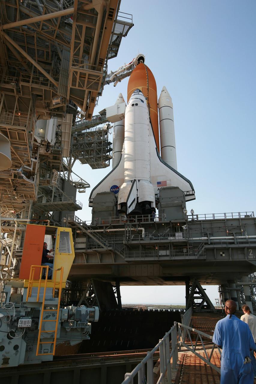 CAPE CANAVERAL, Fla. – On Launch Pad 39A at NASA's Kennedy Space Center in Florida, workers look on as the rotating service structure, or RSS, is rolled back from space shuttle Atlantis.  The RSS is retracted in preparation for Atlantis’ liftoff on the STS-125 mission to service NASA's Hubble Space Telescope.  The rotating structure provides protected access to the shuttle for changeout and servicing of payloads at the pad. After the RSS is rolled back, the orbiter is ready for fuel cell activation and external tank cryogenic propellant loading operations.  Atlantis' crew will service NASA's Hubble Space Telescope for the fifth and final time. The flight will include five spacewalks during which astronauts will refurbish and upgrade the telescope with state-of-the-art science instruments. As a result, Hubble's capabilities will be expanded and its operational lifespan extended through at least 2014. Launch is scheduled for 2:01 p.m. EDT on May 11.  Photo credit: NASA/Dimitri Gerondidakis