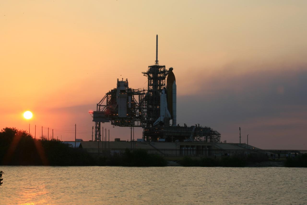 CAPE CANAVERAL, Fla. – The sun sets on Launch Pad 39A at NASA's Kennedy Space Center in Florida following rollback of the pad’s rotating service structure, or RSS, from around space shuttle Atlantis.  The RSS is retracted in preparation for Atlantis’ liftoff on the STS-125 mission to service NASA's Hubble Space Telescope.  The rotating structure provides protected access to the shuttle for changeout and servicing of payloads at the pad. After the RSS is rolled back, the orbiter is ready for fuel cell activation and external tank cryogenic propellant loading operations.  Atlantis' crew will service NASA's Hubble Space Telescope for the fifth and final time. The flight will include five spacewalks during which astronauts will refurbish and upgrade the telescope with state-of-the-art science instruments. As a result, Hubble's capabilities will be expanded and its operational lifespan extended through at least 2014. Launch is scheduled for 2:01 p.m. EDT on May 11.  Photo credit: NASA/Dimitri Gerondidakis