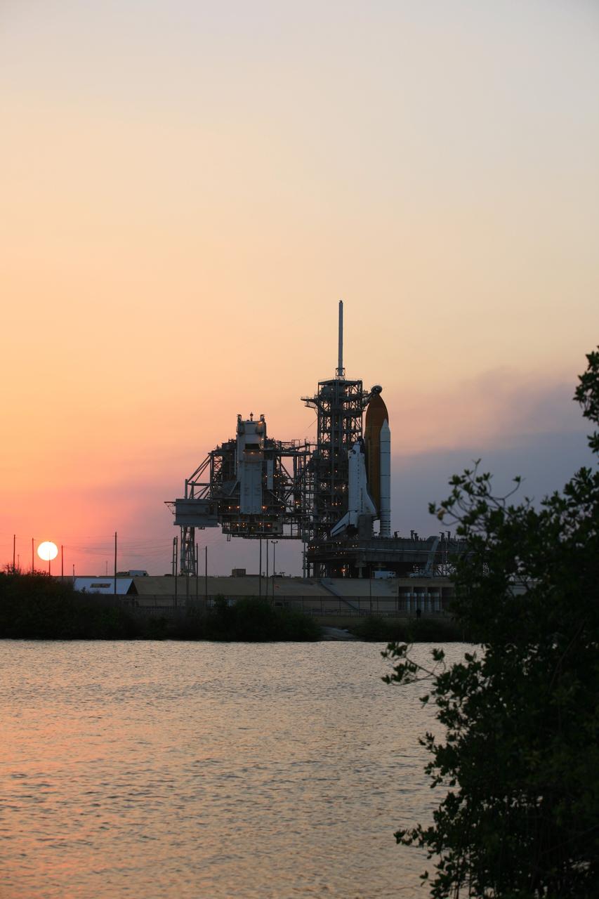 CAPE CANAVERAL, Fla. – The sun sets on a beautiful balmy evening over Launch Pad 39A at NASA's Kennedy Space Center in Florida following rollback of the pad’s rotating service structure, or RSS, from around space shuttle Atlantis.  The RSS is retracted in preparation for Atlantis’ liftoff on the STS-125 mission to service NASA's Hubble Space Telescope.  The rotating structure provides protected access to the shuttle for changeout and servicing of payloads at the pad. After the RSS is rolled back, the orbiter is ready for fuel cell activation and external tank cryogenic propellant loading operations.  Atlantis' crew will service NASA's Hubble Space Telescope for the fifth and final time. The flight will include five spacewalks during which astronauts will refurbish and upgrade the telescope with state-of-the-art science instruments. As a result, Hubble's capabilities will be expanded and its operational lifespan extended through at least 2014. Launch is scheduled for 2:01 p.m. EDT on May 11.  Photo credit: NASA/Dimitri Gerondidakis