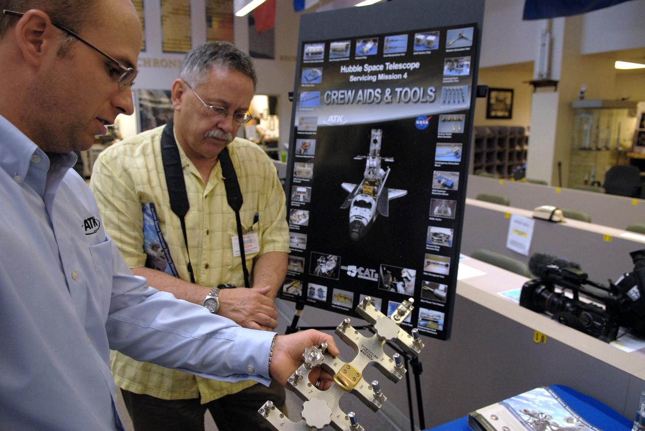 CAPE CANAVERAL, Fla. –  The tools that will be used to service NASA's Hubble Space Telescope on the STS-125 mission are displayed in the NASA News Center at NASA's Kennedy Space Center in Florida.  Being held in the foreground is the grid cutter tool, which will enable removal of the Electromagnetic Interference Grid from the Advanced Camera for Surveys access cover.  On space shuttle Atlantis’ STS-125 mission, Hubble will be serviced for the fifth and final time.  The flight will include five spacewalks during which astronauts will refurbish and upgrade the telescope with these state-of-the-art science instruments. As a result, Hubble's capabilities will be expanded and its operational lifespan extended through at least 2014.  The payload includes a Wide Field Camera 3, fine guidance sensor and the Cosmic Origins Spectrograph. Launch is scheduled for 2:01 p.m. EDT May 11.  Photo credit: NASA/Jack Pfaller