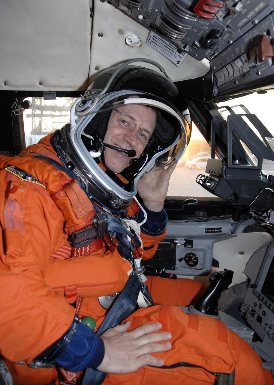 CAPE CANAVERAL, Fla. – On the Shuttle Landing Facility at NASA's Kennedy Space Center in Florida, STS-125 Pilot Gregory C. Johnson, puts on the helmet of his launch-and-entry suit while sitting in the cockpit of the Shuttle Training Aircraft.  He is preparing to practice shuttle landings in preparation for launch of space shuttle Atlantis, scheduled for 2:01 p.m. EDT on May 11. On Atlantis’ STS-125 mission, NASA's Hubble Space Telescope will be serviced for the fifth and final time.  The flight will include five spacewalks during which astronauts will refurbish and upgrade the telescope with state-of-the-art science instruments. As a result, Hubble's capabilities will be expanded and its operational lifespan extended through at least 2014.  Photo credit: NASA/Kim Shiflett