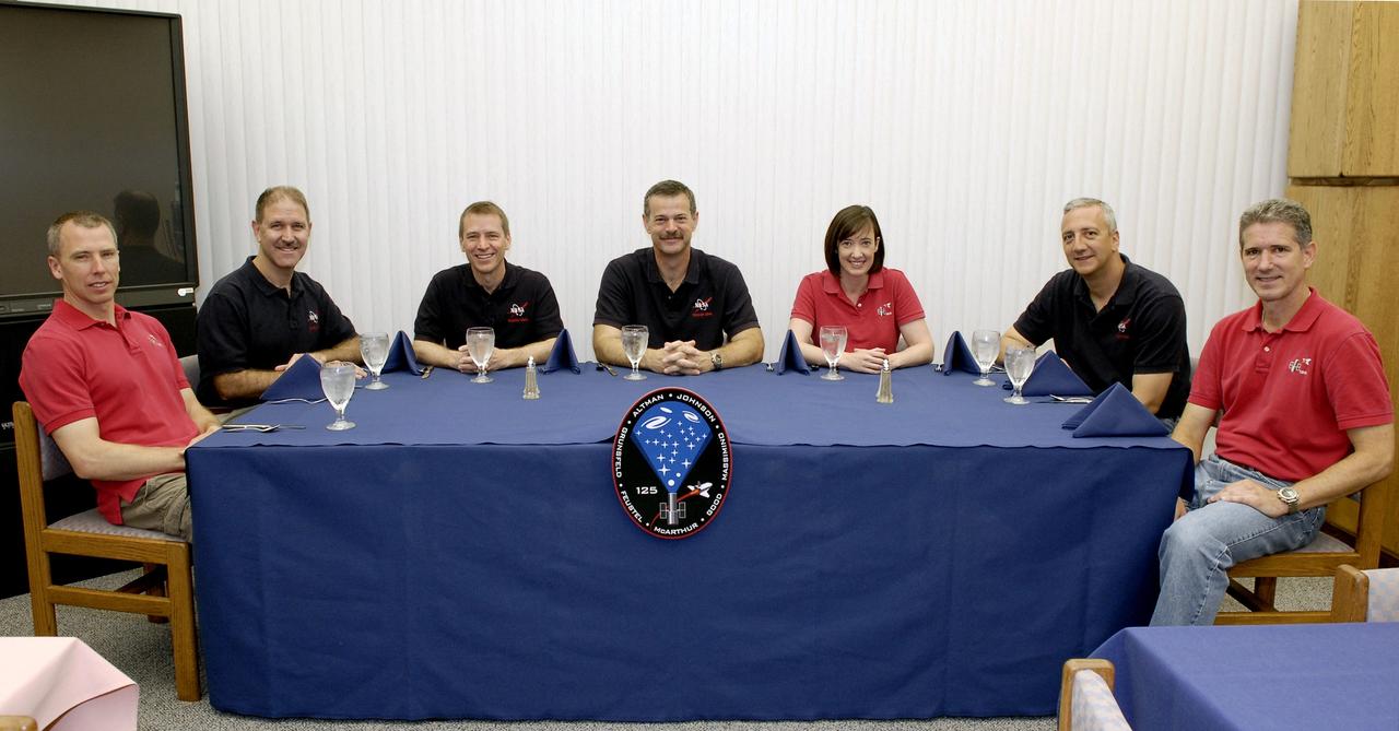 CAPE CANAVERAL, Fla. –  At NASA's Kennedy Space Center in Florida, STS-125 crew members pose for the traditional portrait after breakfast on launch day.  From left are Mission Specialists Andrew Feustel and John Grunsfeld, Pilot Gregory C. Johnson, Commander Scott Altman, and Mission Specialists Megan McArthur, Mike Massimino and Michael Good.  The crew is preparing for liftoff aboard space shuttle Atlantis on the STS-125 mission to refurbish and upgrade NASA's Hubble Space Telescope with state-of-the-art science instruments. The payload includes a Wide Field Camera 3, fine guidance sensor and the Cosmic Origins Spectrograph.  Atlantis' 11-day flight will include five spacewalks that will expand Hubble's capabilities and extend its operational lifespan through at least 2014.  Launch of Atlantis is scheduled for 2:01 p.m. EDT. Photo credit: NASA/Kim Shiflett