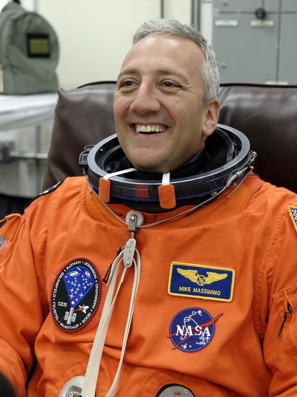 CAPE CANAVERAL, Fla. –  STS-125 Mission Specialist Mike Massimino puts on his launch-and-entry suit before heading for Launch Pad 39A at NASA's Kennedy Space Center in Florida. This launch will be Massimino's second space shuttle flight.  Liftoff is scheduled for 2:01 p.m. May 11 EDT.  Atlantis' 11-day flight will include five spacewalks to refurbish and upgrade NASA's Hubble Space Telescope with state-of-the-art science instruments that will expand Hubble's capabilities and extend its operational lifespan through at least 2014.  The payload includes a Wide Field Camera 3, fine guidance sensor and the Cosmic Origins Spectrograph. Photo credit: NASA/Kim Shiflett