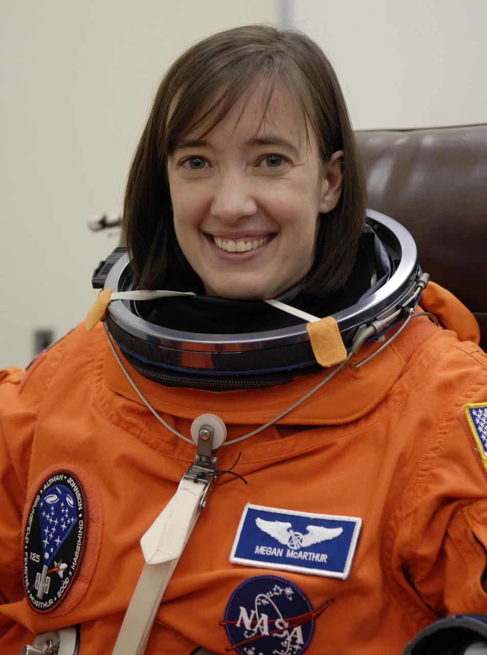 CAPE CANAVERAL, Fla. – STS-125 Mission Specialist Megan McArthur puts on her launch-and-entry suit before heading for Launch Pad 39A at NASA's Kennedy Space Center in Florida. This launch will be McArthur's first space shuttle flight.  Liftoff is scheduled for 2:01 p.m. May 11 EDT. Atlantis' 11-day flight will include five spacewalks to refurbish and upgrade NASA's Hubble Space Telescope with state-of-the-art science instruments that will expand Hubble's capabilities and extend its operational lifespan through at least 2014.  The payload includes a Wide Field Camera 3, fine guidance sensor and the Cosmic Origins Spectrograph. Photo credit: NASA/Kim Shiflett