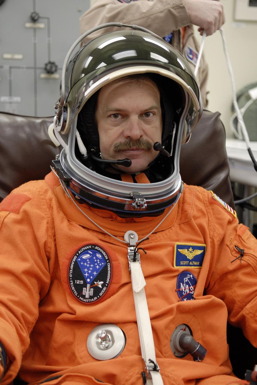CAPE CANAVERAL, Fla. – STS-125 Commander Scott Altman fits his helmet to his launch-and-entry suit before heading for Launch Pad 39A at NASA's Kennedy Space Center in Florida. This launch will be Altman's fourth space shuttle flight.  Liftoff is scheduled for 2:01 p.m. May 11 EDT.  Atlantis' 11-day flight will include five spacewalks to refurbish and upgrade NASA's Hubble Space Telescope with state-of-the-art science instruments that will expand Hubble's capabilities and extend its operational lifespan through at least 2014.  The payload includes a Wide Field Camera 3, fine guidance sensor and the Cosmic Origins Spectrograph. Photo credit: NASA/Kim Shiflett