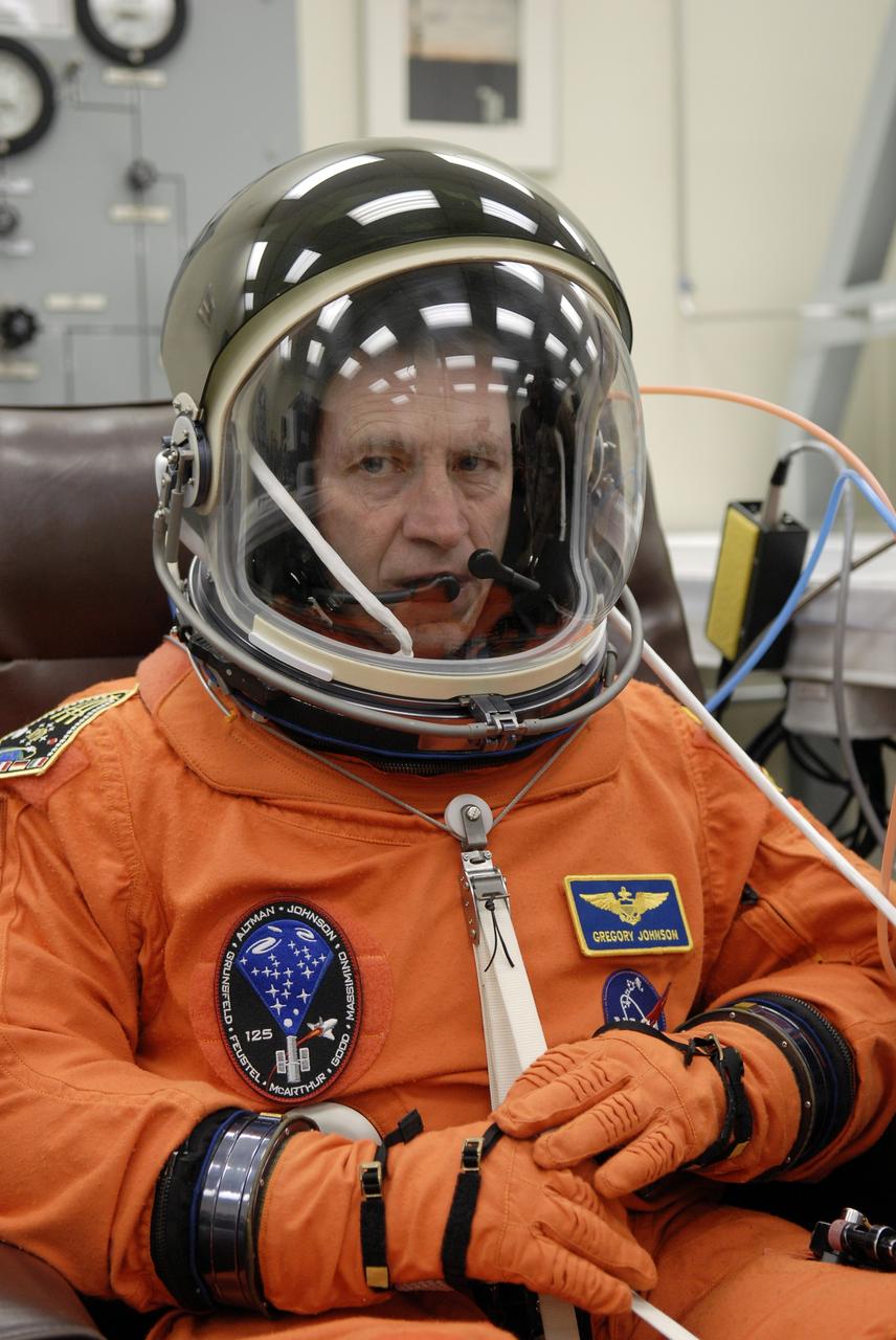 CAPE CANAVERAL, Fla. – STS-125 Pilot Gregory C. Johnson fits his helmet and gloves on his launch-and-entry suit before heading for Launch Pad 39A at NASA's Kennedy Space Center in Florida. This launch will be Johnson's first space shuttle flight.  Liftoff is scheduled for 2:01 p.m. May 11 EDT.  Atlantis' 11-day flight will include five spacewalks to refurbish and upgrade NASA's Hubble Space Telescope with state-of-the-art science instruments that will expand Hubble's capabilities and extend its operational lifespan through at least 2014.  The payload includes a Wide Field Camera 3, fine guidance sensor and the Cosmic Origins Spectrograph. Photo credit: NASA/Kim Shiflett