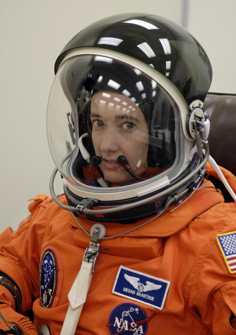 CAPE CANAVERAL, Fla. – STS-125 Mission Specialist Megan McArthur fits the helmet on her launch-and-entry suit before heading for Launch Pad 39A at NASA's Kennedy Space Center in Florida. This launch will be McArthur's first space shuttle flight.  Liftoff is scheduled for 2:01 p.m. May 11 EDT.  Atlantis' 11-day flight will include five spacewalks to refurbish and upgrade NASA's Hubble Space Telescope with state-of-the-art science instruments that will expand Hubble's capabilities and extend its operational lifespan through at least 2014.  The payload includes a Wide Field Camera 3, fine guidance sensor and the Cosmic Origins Spectrograph. Photo credit: NASA/Kim Shiflett
