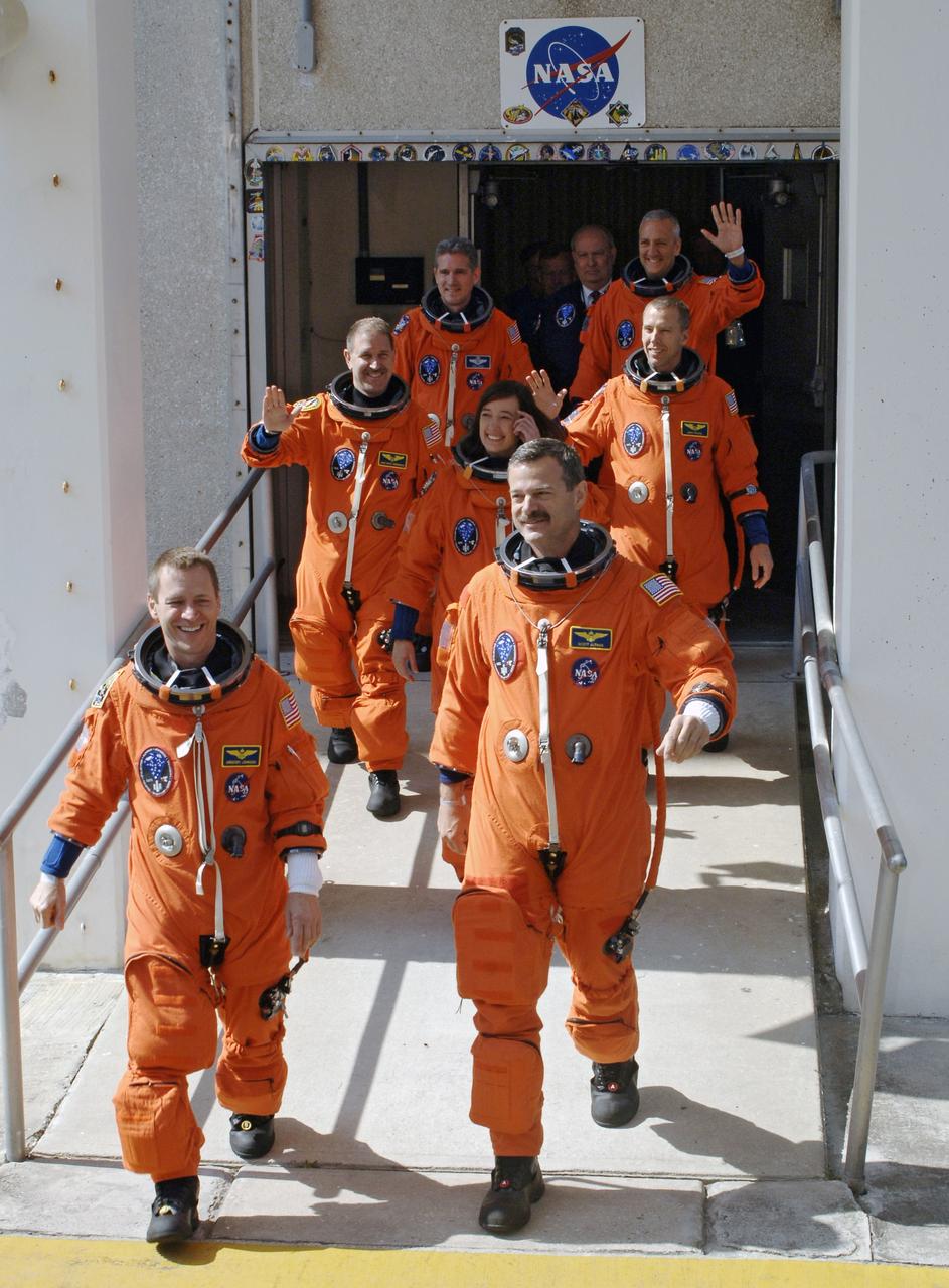 CAPE CANAVERAL, Fla. – STS-125 crew members eagerly stride from the Operations and Checkout Building at NASA's Kennedy Space Center in Florida to make the trip to Launch Pad 39A for liftoff of space shuttle Atlantis on the STS-125 mission to service NASA's Hubble Space Telescope. On the left, front to back, are Pilot Gregory C. Johnson and Mission Specialists John Grunsfeld and Michael Good. On the right, front to back, are Commander Scott Altman and Mission Specialists Megan McArthur, Andrew Feustel and Mike Massimino. Atlantis' 11-day flight will include five spacewalks to refurbish and upgrade the telescope with state-of-the-art science instruments that will expand Hubble's capabilities and extend its operational lifespan through at least 2014. The payload includes a Wide Field Camera 3, fine guidance sensor and the Cosmic Origins Spectrograph. Launch of Atlantis is scheduled for 2:01 p.m. May 11 EDT. Photo credit: NASA/Kim Shiflett