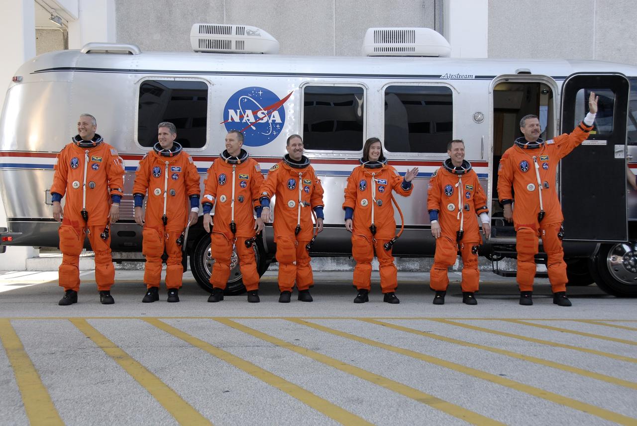 CAPE CANAVERAL, Fla. – STS-125 crew members acknowledge the spectators who have gathered to wish them well on their mission aboard space shuttle Atlantis to service NASA's Hubble Space Telescope. From left are Mission Specialists Mike Massimino, Michael Good, Andrew Feustel, John Grunsfeld and Megan McArthur, Pilot Gregory C. Johnson and Commander Scott Altman.  Atlantis' 11-day flight will include five spacewalks to refurbish and upgrade the telescope with state-of-the-art science instruments that will expand Hubble's capabilities and extend its operational lifespan through at least 2014.  The payload includes a Wide Field Camera 3, fine guidance sensor and the Cosmic Origins Spectrograph. Launch of Atlantis is scheduled for 2:01 p.m. May 11 EDT.   Photo credit: NASA/Kim Shiflett