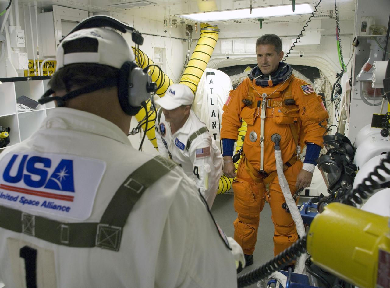 CAPE CANAVERAL, Fla. – In the White Room on Launch Pad 39A at NASA's Kennedy Space Center in Florida, STS-125 Mission Specialist Michael Good prepares to enter space shuttle Atlantis for launch. The White Room is at the end of the orbiter access arm on the fixed service structure and provides access into the shuttle. Atlantis' 11-day flight will include five spacewalks to refurbish and upgrade the telescope with state-of-the-art science instruments that will expand Hubble's capabilities and extend its operational lifespan through at least 2014. The payload includes a Wide Field Camera 3, fine guidance sensor and the Cosmic Origins Spectrograph. Launch of Atlantis on the STS-125 mission is scheduled for 2:01 p.m. May 11 EDT. Photo credit: NASA/Sandra Joseph-Kevin O'Connell