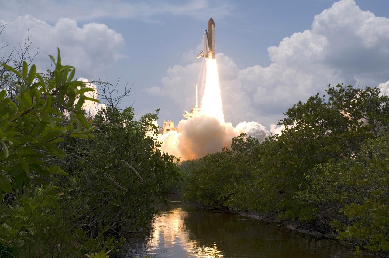 CAPE CANAVERAL, Fla. – Banks of trees and bushes provide a frame for the launch of space shuttle Atlantis from Launch Pad 39A at NASA's Kennedy Space Center in Florida.  Atlantis will rendezvous with NASA's Hubble Space Telescope on the STS-125 mission. Liftoff was on time at 2:01 p.m. EDT. Atlantis' 11-day flight will include five spacewalks to refurbish and upgrade the telescope with state-of-the-art science instruments that will expand Hubble's capabilities and extend its operational lifespan through at least 2014.  The payload includes a Wide Field Camera 3, fine guidance sensor and the Cosmic Origins Spectrograph.  Photo credit: NASA/Sandra Joseph-Kevin O'Connell