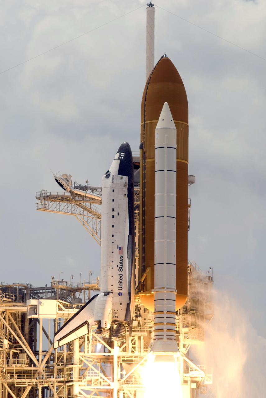 CAPE CANAVERAL, Fla. – On Launch Pad 39A at NASA's Kennedy Space Center in Florida, space shuttle Atlantis rises past the fixed service structure as it races toward space on the STS-125 mission. Atlantis will rendezvous with NASA's Hubble Space Telescope on the STS-125 mission.  Liftoff was on time at 2:01 p.m. EDT. Atlantis' 11-day flight will include five spacewalks to refurbish and upgrade the telescope with state-of-the-art science instruments that will expand Hubble's capabilities and extend its operational lifespan through at least 2014.  The payload includes a Wide Field Camera 3, fine guidance sensor and the Cosmic Origins Spectrograph.  Photo credit: NASA/Michael Gayle-Rusty Backer