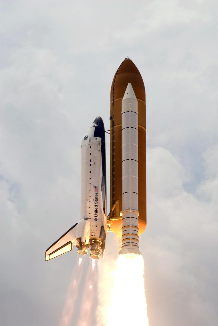 CAPE CANAVERAL, Fla. – Space shuttle Atlantis roars into the cloudy sky above Launch Pad 39A at NASA's Kennedy Space Center in Florida on the STS-125 mission.  Blue cones of light, mach diamonds, can be seen beneath the engine nozzles. The mach diamonds are a formation of shock waves in the exhaust plume of an aerospace propulsion system. Atlantis will rendezvous with NASA's Hubble Space Telescope on the STS-125 mission.  Liftoff was on time at 2:01 p.m. EDT. Atlantis' 11-day flight will include five spacewalks to refurbish and upgrade the telescope with state-of-the-art science instruments that will expand Hubble's capabilities and extend its operational lifespan through at least 2014.  The payload includes a Wide Field Camera 3, fine guidance sensor and the Cosmic Origins Spectrograph.  Photo credit: NASA/Michael Gayle-Rusty Backer