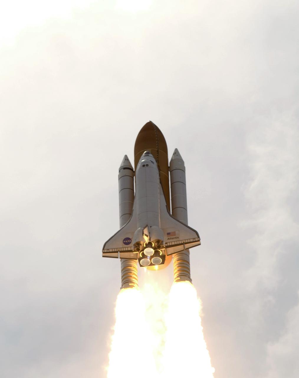 CAPE CANAVERAL, Fla. – Atop twin columns of fire, space shuttle Atlantis roars into the cloudy sky above Launch Pad 39A at NASA's Kennedy Space Center in Florida on the STS-125 mission. Atlantis will rendezvous with NASA's Hubble Space Telescope on the STS-125 mission.  Liftoff was on time at 2:01 p.m. EDT.  Atlantis' 11-day flight will include five spacewalks to refurbish and upgrade the telescope with state-of-the-art science instruments that will expand Hubble's capabilities and extend its operational lifespan through at least 2014.  The payload includes a Wide Field Camera 3, fine guidance sensor and the Cosmic Origins Spectrograph.  Photo credit: NASA/Michael Gayle-Rusty Backer