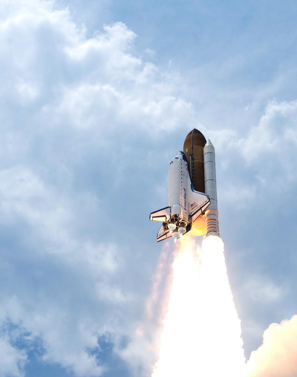 CAPE CANAVERAL, Fla. – Space shuttle Atlantis roars into the cloudy sky above Launch Pad 39A at NASA's Kennedy Space Center in Florida on the STS-125 mission.  Blue cones of light, mach diamonds, can be seen beneath the engine nozzles. The mach diamonds are a formation of shock waves in the exhaust plume of an aerospace propulsion system. Atlantis will rendezvous with NASA's Hubble Space Telescope.  Liftoff was on time at 2:01 p.m. EDT. Atlantis' 11-day flight will include five spacewalks to refurbish and upgrade the telescope with state-of-the-art science instruments that will expand Hubble's capabilities and extend its operational lifespan through at least 2014.  The payload includes a Wide Field Camera 3, fine guidance sensor and the Cosmic Origins Spectrograph.  Photo credit: NASA/Tony Gray-Tom Farrar