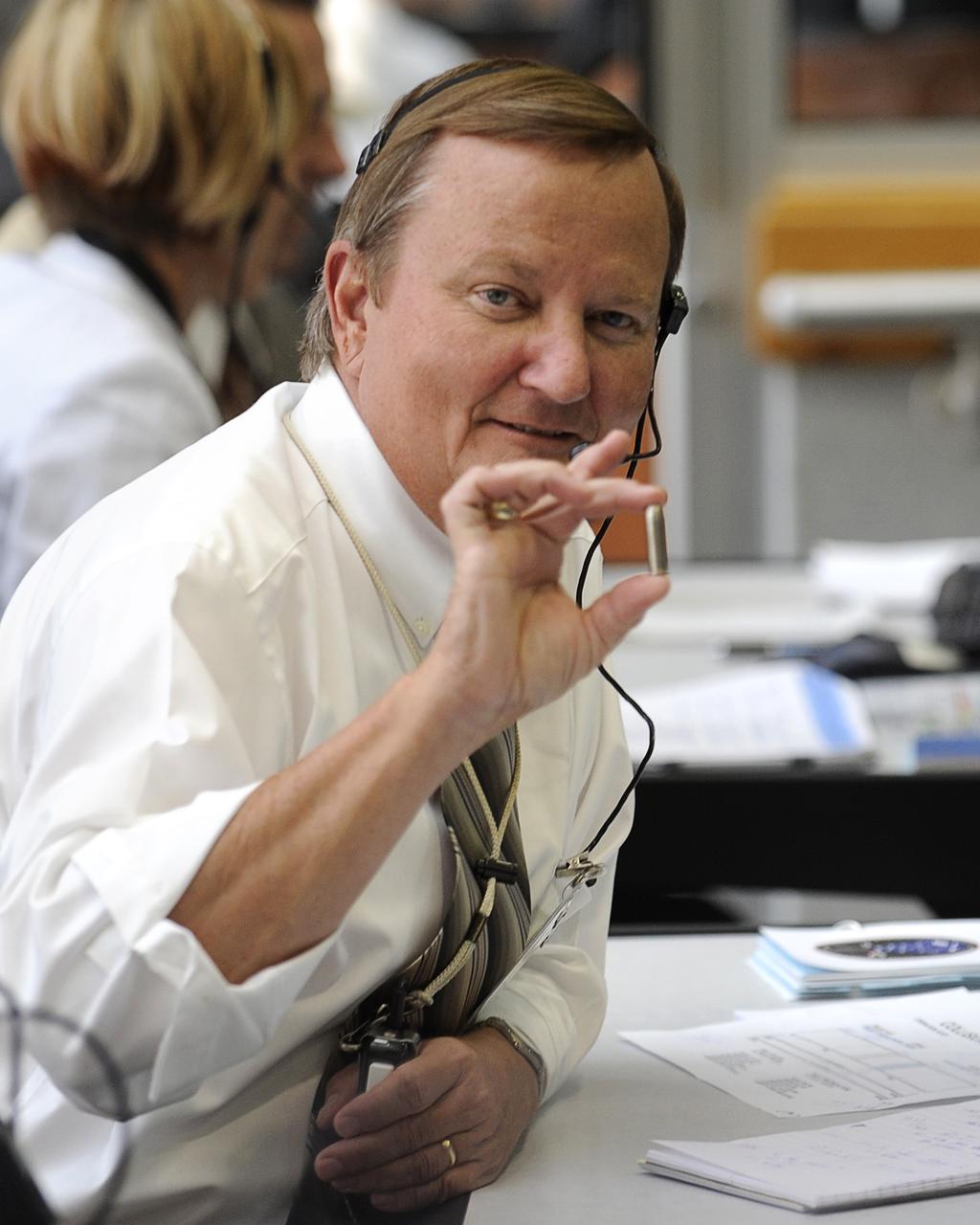 CAPE CANAVERAL, Fla. – NASA Shuttle Launch Director Michael Leinbach shows his lucky silver bullet while in firing room #4 of the NASA Kennedy Space Center's Launch Control Center, Monday, May 11, 2009, at Cape Canaveral, Fla. Leinbach carries the inert silver bullet as a good luck charm. Space shuttle Atlantis with its seven-member crew launched at 2:01 p.m. EDT Monday from Kennedy on the final Hubble Space Telescope servicing mission.  Photo credit: NASA/Bill Ingalls