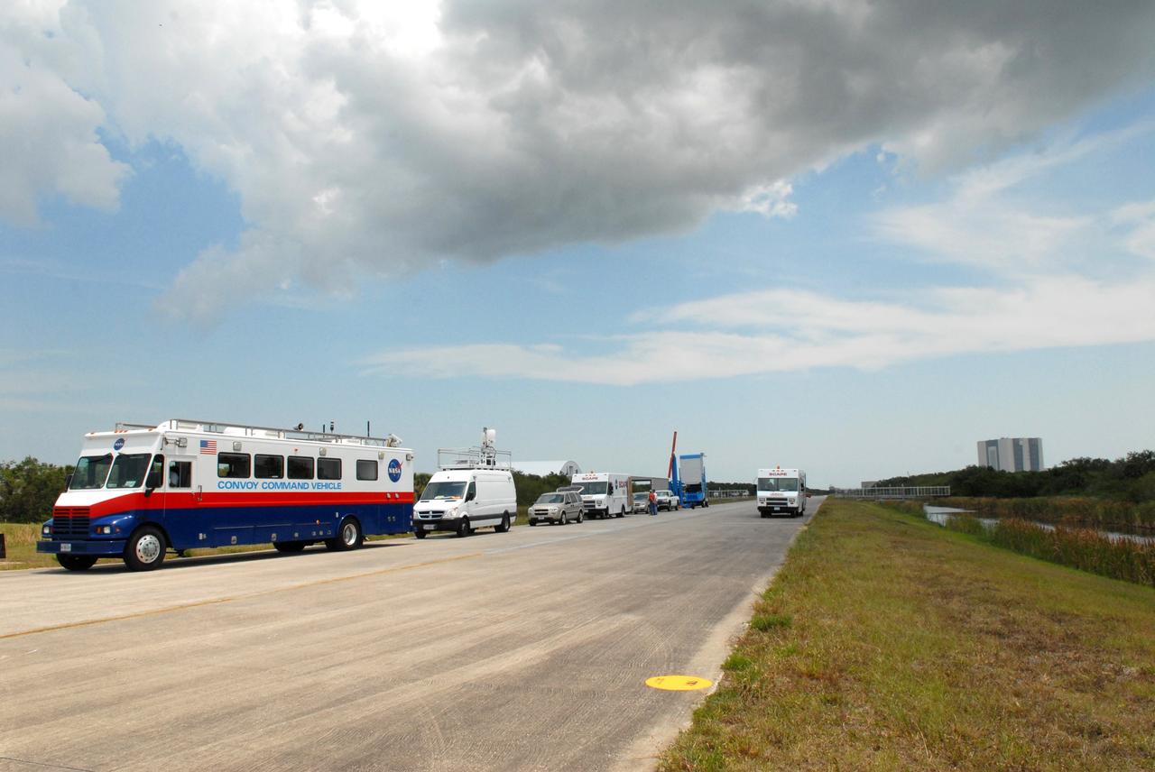 CAPE CANAVERAL, Fla. – The mini-convoy is lined up on the Shuttle Landing Facility runway at NASA's Kennedy Space Center in Florida awaiting space shuttle Atlantis' launch on the STS-125 mission to service NASA's Hubble Space Telescope. The convoy is prepared to act should the shuttle need to return to the launch site in the event of an emergency. At left is the Convoy Command Vehicle which is the command post for the convoy commander. Atlantis launched successfully on time at 2:01 p.m. EDT. Atlantis' 11-day flight will include five spacewalks to refurbish and upgrade the telescope with state-of-the-art science instruments that will expand Hubble's capabilities and extend its operational lifespan through at least 2014.  The payload includes a Wide Field Camera 3, Fine Guidance Sensor and the Cosmic Origins Spectrograph.   Photo credit: NASA/Jack Pfaller