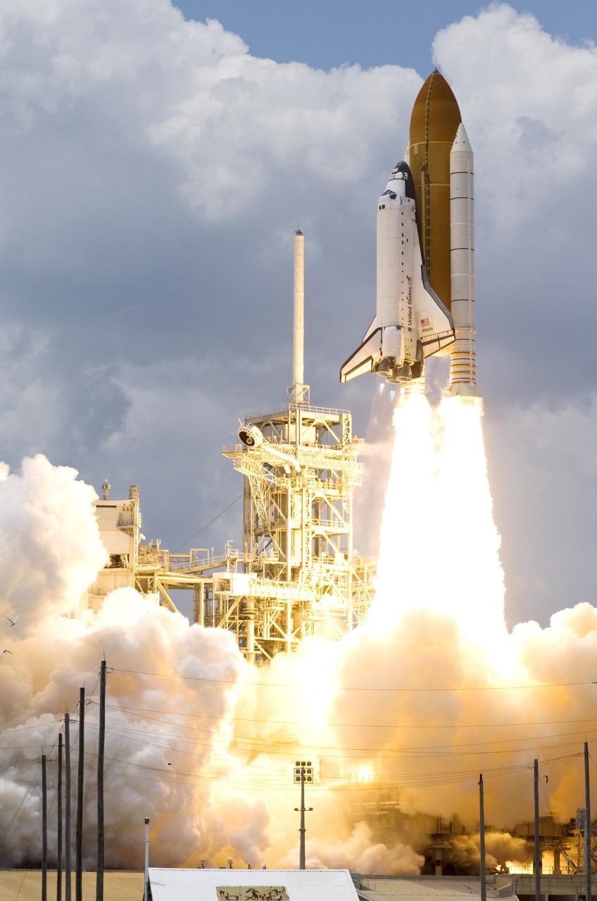 CAPE CANAVERAL, Fla. – Under a slow-building cloud bank, space shuttle Atlantis hurtles past the lightning mast on top of the fixed service structure on Launch Pad 39A at NASA's Kennedy Space Center in Florida. Atlantis will rendezvous with NASA's Hubble Space Telescope on the STS-125 service mission.  Liftoff was on-time at 2:01 p.m. EDT.  Atlantis' 11-day flight will include five spacewalks to refurbish and upgrade the telescope with state-of-the-art science instruments that will expand Hubble's capabilities and extend its operational lifespan through at least 2014.  The payload includes a Wide Field Camera 3, Fine Guidance Sensor and the Cosmic Origins Spectrograph.   Photo courtesy of Scott Andrews