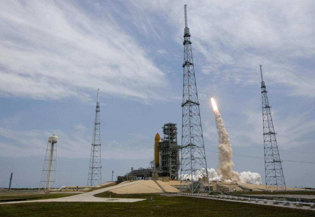 CAPE CANAVERAL, Fla. – The launch of space shuttle Atlantis from Launch Pad 39A at NASA's Kennedy Space Center in Florida is viewed from behind Launch Pad 39B. On pad 39B is space shuttle Endeavour, which can launch, if needed, for rescue of Atlantis’ crew during its STS-125 mission to service NASA’s Hubble Space Telescope.  Liftoff of Atlantis was on time at 2:01 p.m. EDT.   Atlantis' 11-day flight will include five spacewalks to refurbish and upgrade the telescope with state-of-the-art science instruments that will expand Hubble's capabilities and extend its operational lifespan through at least 2014.  The payload includes a Wide Field Camera 3, Fine Guidance Sensor and the Cosmic Origins Spectrograph.   Photo courtesy of Scott Andrews