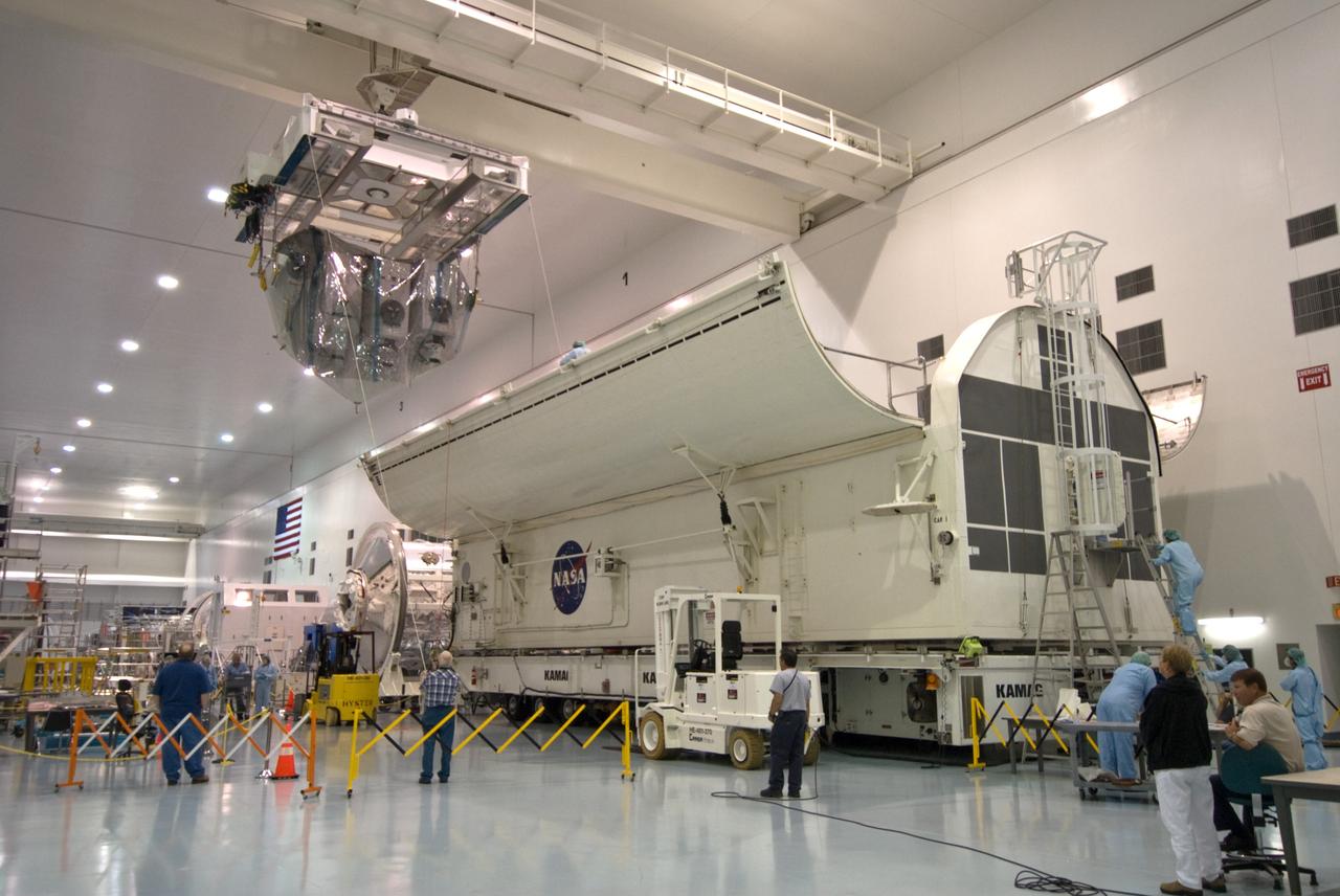 CAPE CANAVERAL, Fla. – In the Space Station Processing Facility at NASA's Kennedy Space Center in Florida, an overhead crane carries the Kibo Experiment Logistics Module Exposed Section, or ELM-ES, toward the payload canister, at right. The canister will transport the payload to Launch Pad 39A. The ELM-ES is one of the final components of the Japan Aerospace Exploration Agency's Kibo laboratory for the International Space Station. It can provide payload storage space and can carry up to three payloads at launch. The canister will deliver the ELM-ES and other elements to Launch Pad 39A for installation in space shuttle Endeavour's payload bay. The STS-127 mission is targeted for launch June 13.  Photo credit: NASA/Jack Pfaller