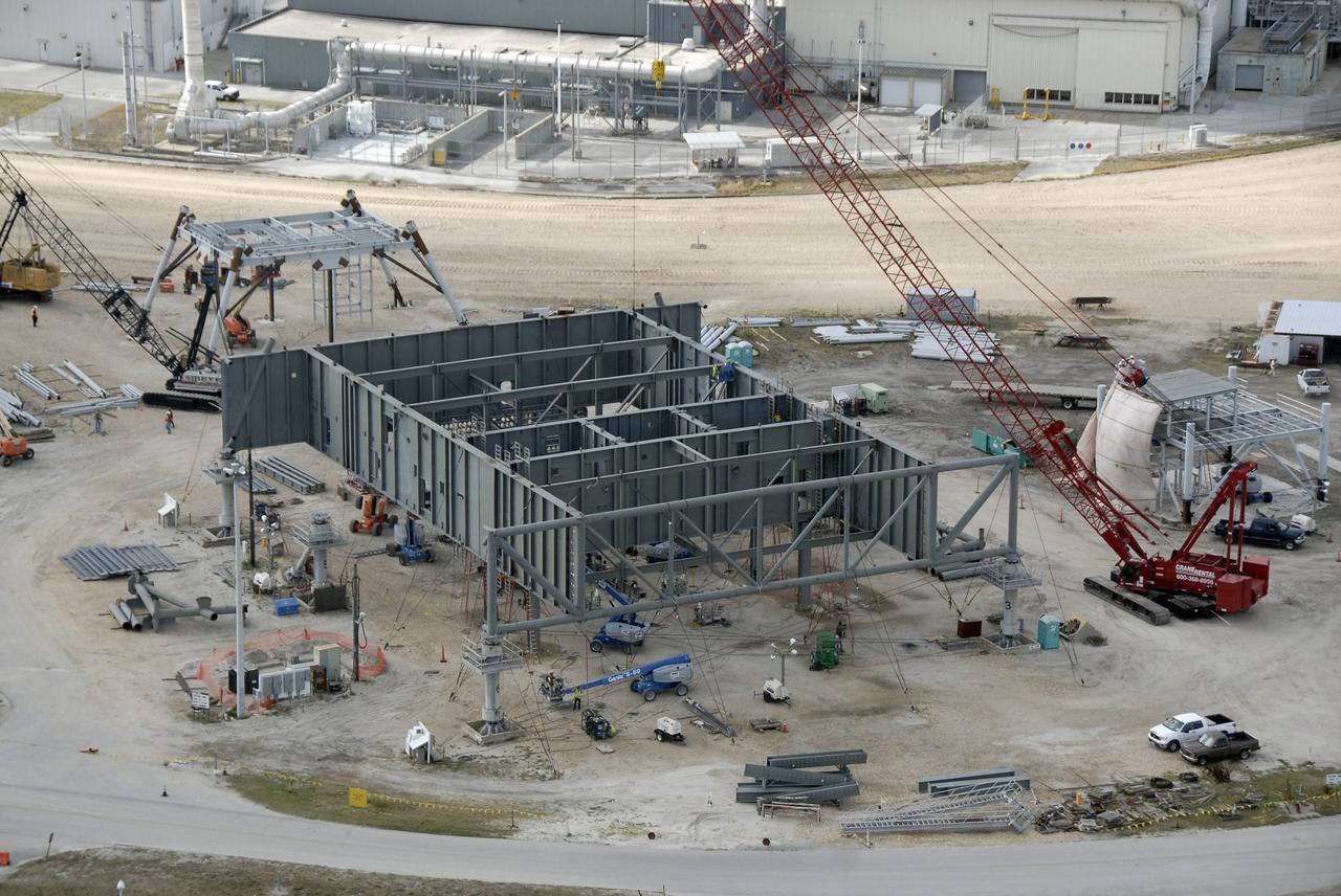 CAPE CANAVERAL, Fla. – In the mobile launcher parking area behind the Vehicle Assembly Building at NASA's Kennedy Space Center in Florida, the new mobile launcher, or ML, for the Ares rockets is under construction. The ML will be the base to launch the Orion crew exploration vehicle and the cargo vehicle. The base is being made lighter than space shuttle mobile launcher platforms so the crawler-transporter can pick up the added load of the 345-foot tower and taller rocket. When the structural portion of the new mobile launcher is complete, umbilicals, access arms, communications equipment and command/control equipment will be installed. Photo credit: NASA/Kim Shiflett
