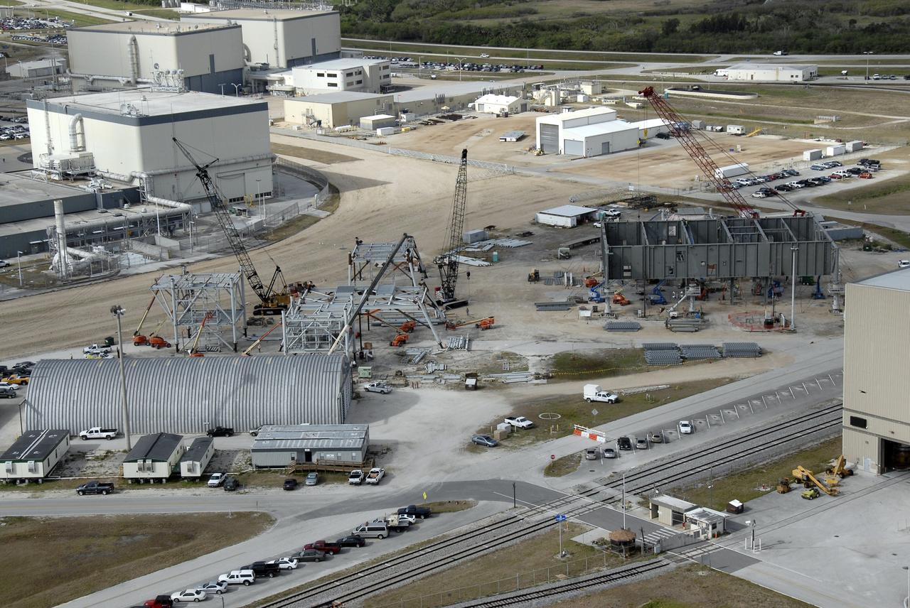 CAPE CANAVERAL, Fla. – In the mobile launcher parking area behind the Vehicle Assembly Building at NASA's Kennedy Space Center in Florida, the new mobile launcher, or ML, (at right) for the Ares rockets is under construction. The ML will be the base to launch the Orion crew exploration vehicle and the cargo vehicle. The base is being made lighter than space shuttle mobile launcher platforms so the crawler-transporter can pick up the added load of the 345-foot tower and taller rocket. When the structural portion of the new mobile launcher is complete, umbilicals, access arms, communications equipment and command/control equipment will be installed. Photo credit: NASA/Kim Shiflett