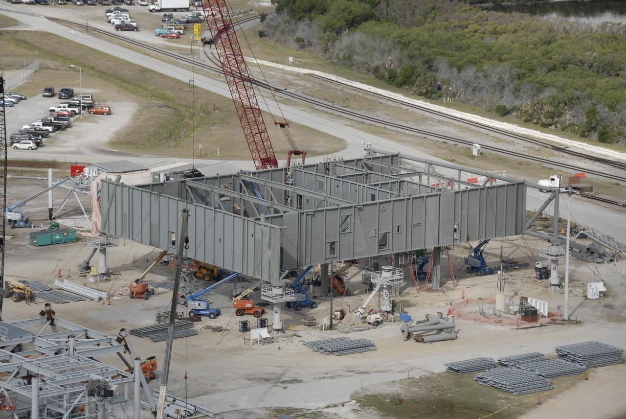 CAPE CANAVERAL, Fla. – In the mobile launcher parking area behind the Vehicle Assembly Building, at NASA's Kennedy Space Center in Florida, the new mobile launcher, or ML, for the Ares rockets is under construction. The ML will be the base to launch the Orion crew exploration vehicle and the cargo vehicle. The base is being made lighter than space shuttle mobile launcher platforms so the crawler-transporter can pick up the added load of the 345-foot tower and taller rocket. When the structural portion of the new mobile launcher is complete, umbilicals, access arms, communications equipment and command/control equipment will be installed. Photo credit: NASA/Kim Shiflett