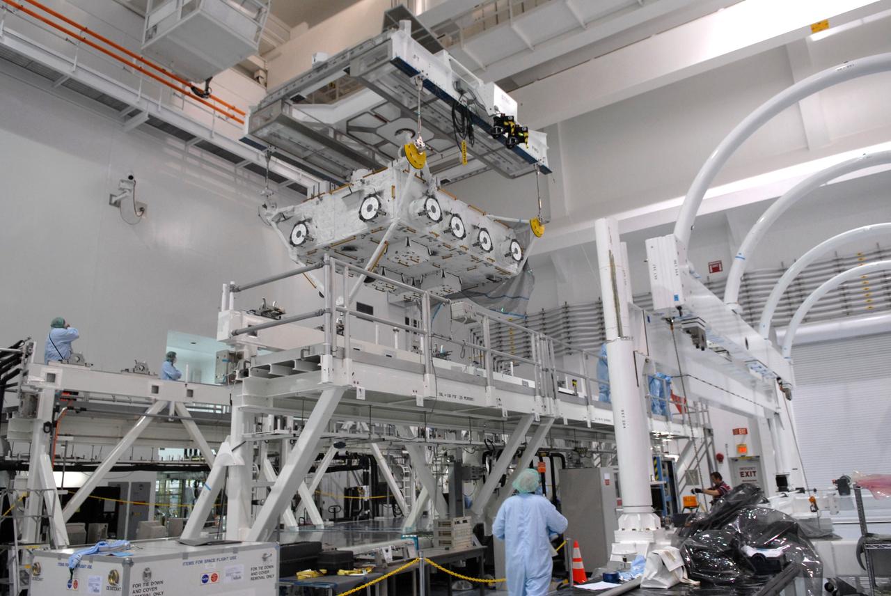 CAPE CANAVERAL, Fla. – In the Space Station Processing Facility at NASA's Kennedy Space Center in Florida, an overhead crane lifts the the Japan Aerospace Exploration Agency's Kibo Exposed Facility, or EF, part of the payload for the STS-127 mission, from its stand. The module will be transferred to the payload canister.  The EF, along with the Experiment Logistics Module Exposed Section, will be carried aboard space shuttle Endeavour on the STS-127 mission targeted for launch June 13. When the EF is installed on the Kibo laboratory, it will provide a multipurpose platform where science experiments can be deployed and operated in the exposed environment. The payloads attached to the EF can be exchanged or retrieved by Kibo's robotic arm, the JEM Remote Manipulator.  Photo credit: NASA/Jack Pfaller