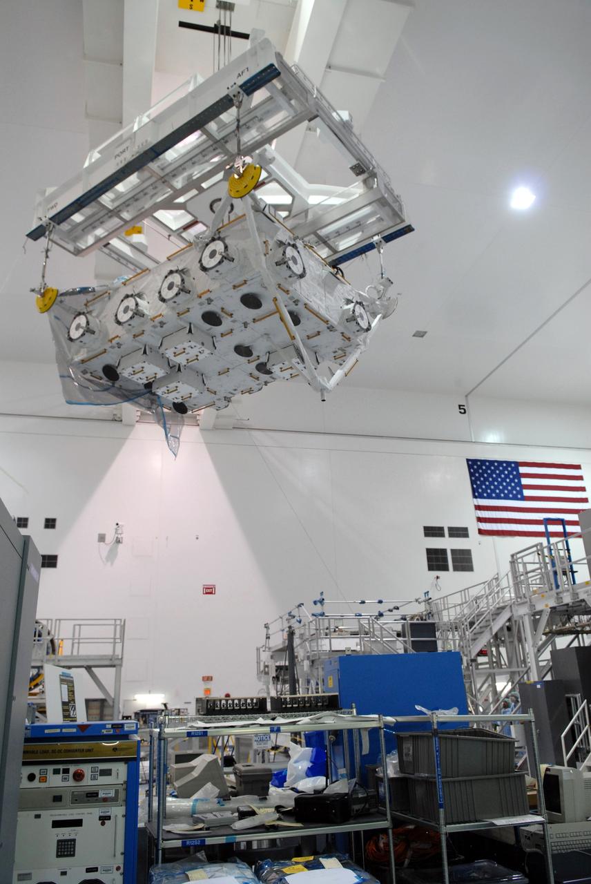 CAPE CANAVERAL, Fla. – In the Space Station Processing Facility at NASA's Kennedy Space Center in Florida, an overhead crane moves the the Japan Aerospace Exploration Agency's Kibo Exposed Facility, or EF, part of the payload for the STS-127 mission, across the floor toward the payload canister. The EF, along with the Experiment Logistics Module Exposed Section, will be carried aboard space shuttle Endeavour on the STS-127 mission targeted for launch June 13. When the EF is installed on the Kibo laboratory, it will provide a multipurpose platform where science experiments can be deployed and operated in the exposed environment. The payloads attached to the EF can be exchanged or retrieved by Kibo's robotic arm, the JEM Remote Manipulator. Photo credit: NASA/Jack Pfaller