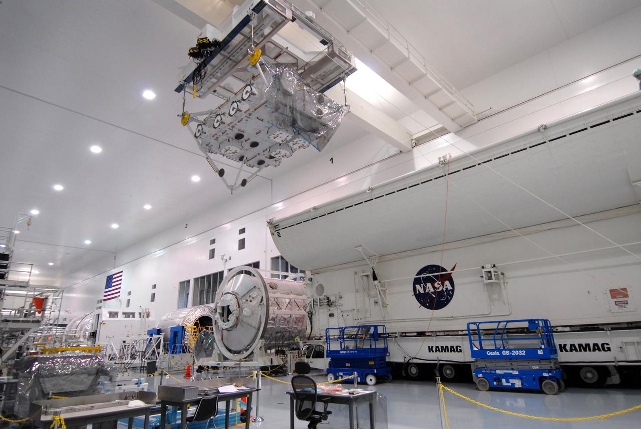 CAPE CANAVERAL, Fla. – In the Space Station Processing Facility at NASA's Kennedy Space Center in Florida, an overhead crane moves the the Japan Aerospace Exploration Agency's Kibo Exposed Facility, or EF, part of the payload for the STS-127 mission, to the payload canister, at right. The EF, along with the Experiment Logistics Module Exposed Section, will be carried aboard space shuttle Endeavour on the STS-127 mission targeted for launch June 13. When the EF is installed on the Kibo laboratory, it will provide a multipurpose platform where science experiments can be deployed and operated in the exposed environment. The payloads attached to the EF can be exchanged or retrieved by Kibo's robotic arm, the JEM Remote Manipulator.  Photo credit: NASA/Jack Pfaller