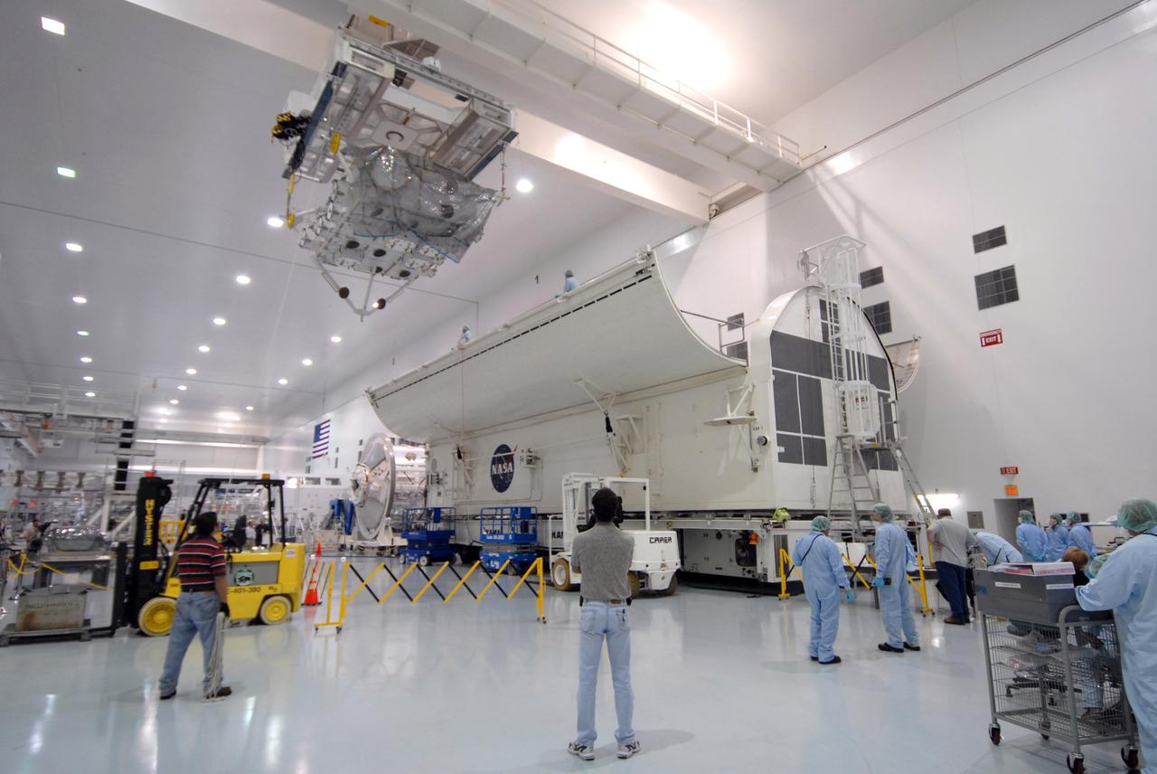 CAPE CANAVERAL, Fla. – In the Space Station Processing Facility at NASA's Kennedy Space Center in Florida, an overhead crane moves the Japan Aerospace Exploration Agency's Kibo Exposed Facility, or EF, part of the payload for the STS-127 mission, to the payload canister, at right. The EF, along with the Experiment Logistics Module Exposed Section, will be carried aboard space shuttle Endeavour on the STS-127 mission targeted for launch June 13. When the EF is installed on the Kibo laboratory, it will provide a multipurpose platform where science experiments can be deployed and operated in the exposed environment. The payloads attached to the EF can be exchanged or retrieved by Kibo's robotic arm, the JEM Remote Manipulator.  Photo credit: NASA/Jack Pfaller