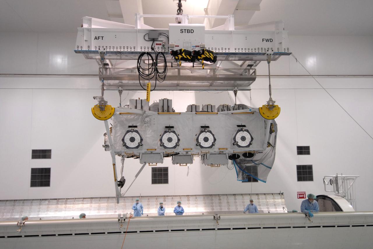 CAPE CANAVERAL, Fla. – In the Space Station Processing Facility at NASA's Kennedy Space Center in Florida, an overhead crane lowers the Japan Aerospace Exploration Agency's Kibo Exposed Facility, or EF, part of the payload for the STS-127 mission, toward the payload canister.  The EF, along with the Experiment Logistics Module Exposed Section, will be carried aboard space shuttle Endeavour on the STS-127 mission targeted for launch June 13. When the EF is installed on the Kibo laboratory, it will provide a multipurpose platform where science experiments can be deployed and operated in the exposed environment. The payloads attached to the EF can be exchanged or retrieved by Kibo's robotic arm, the JEM Remote Manipulator.  Photo credit: NASA/Jack Pfaller