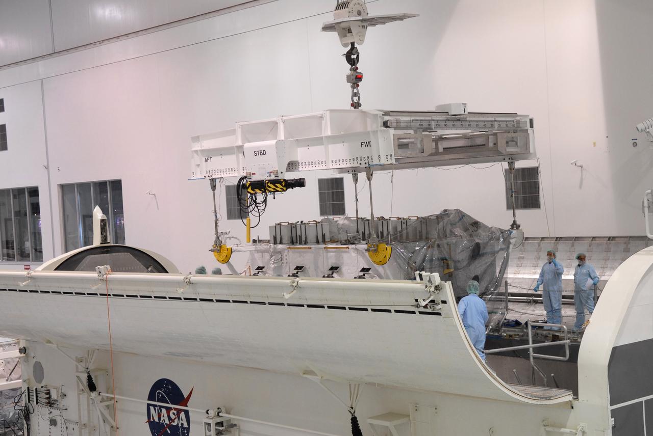 CAPE CANAVERAL, Fla. – In the Space Station Processing Facility at NASA's Kennedy Space Center in Florida, an overhead crane lowers the the Japan Aerospace Exploration Agency's Kibo Exposed Facility, or EF, part of the payload for the STS-127 mission, into the payload canister.  The EF, along with the Experiment Logistics Module Exposed Section, will be carried aboard space shuttle Endeavour on the STS-127 mission targeted for launch June 13. When the EF is installed on the Kibo laboratory, it will provide a multipurpose platform where science experiments can be deployed and operated in the exposed environment. The payloads attached to the EF can be exchanged or retrieved by Kibo's robotic arm, the JEM Remote Manipulator.  Photo credit: NASA/Jack Pfaller