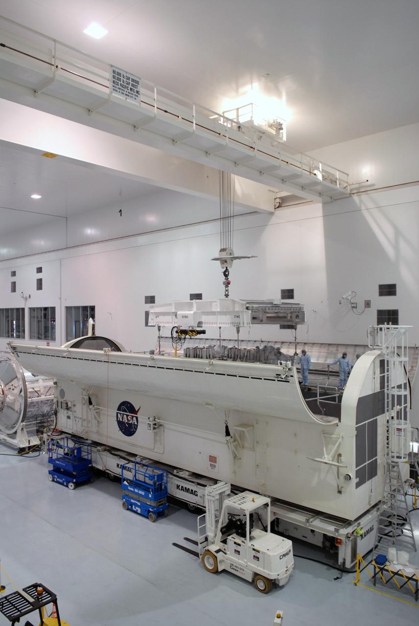 CAPE CANAVERAL, Fla. – In the Space Station Processing Facility at NASA's Kennedy Space Center in Florida, an overhead crane lowers the the Japan Aerospace Exploration Agency's Kibo Exposed Facility, or EF, part of the payload for the STS-127 mission, into the payload canister. The EF, along with the Experiment Logistics Module Exposed Section, will be carried aboard space shuttle Endeavour on the STS-127 mission targeted for launch June 13. When the EF is installed on the Kibo laboratory, it will provide a multipurpose platform where science experiments can be deployed and operated in the exposed environment. The payloads attached to the EF can be exchanged or retrieved by Kibo's robotic arm, the JEM Remote Manipulator.  Photo credit: NASA/Jack Pfaller