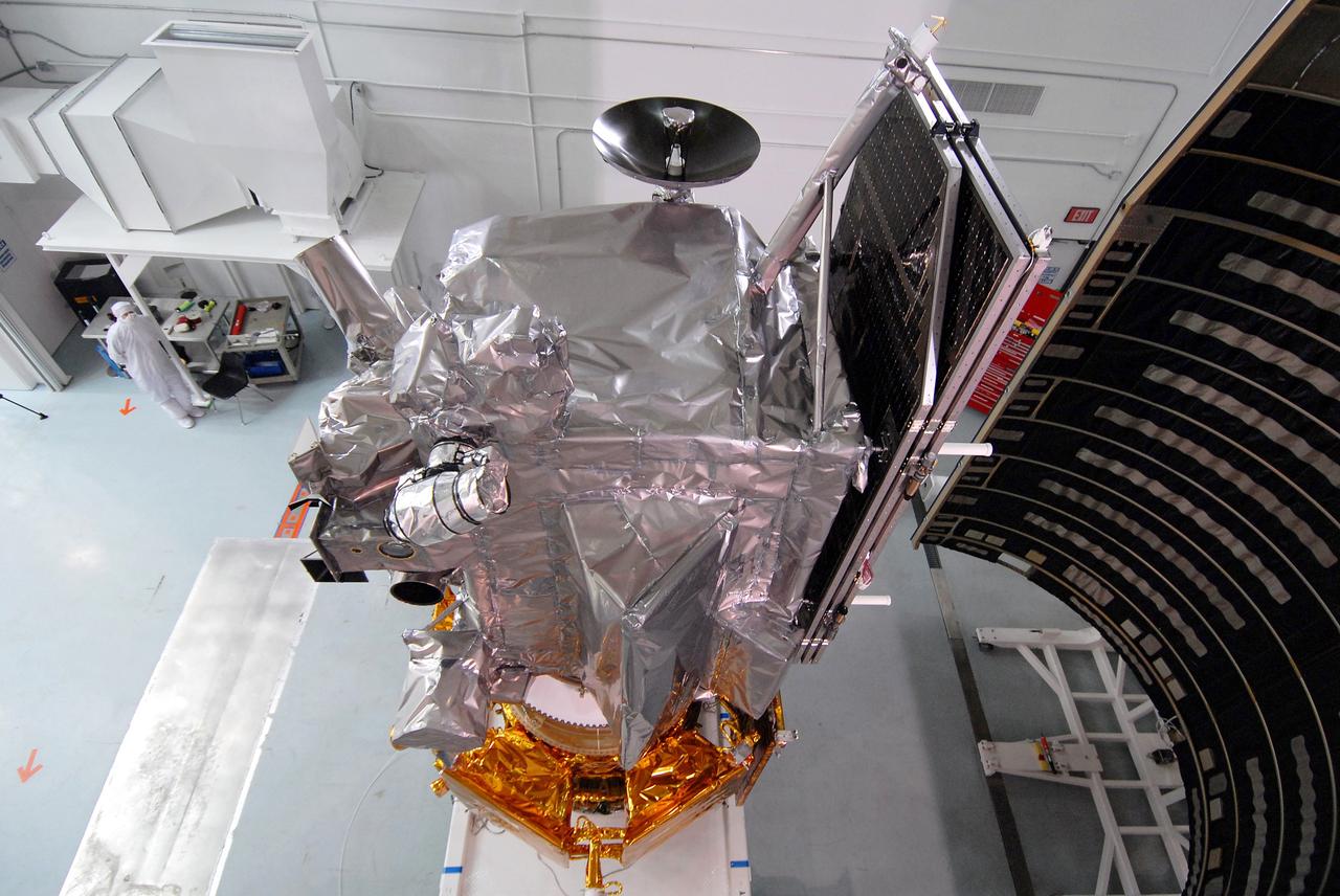 CAPE CANAVERAL, Fla. – At Astrotech Space Operations Facility in Titusville, Fla., NASA's Lunar Reconnaissance Orbiter, or LRO, and NASA's Lunar Crater Observation and Sensing Satellite, known as LCROSS, are being prepared for fairing installation. On the right side of the LRO is part of the solar array.  At far right is part of the fairing that will be installed around the spacecraft for launch.  The fairing is a molded structure that fits flush with the outside surface of the rocket and forms an aerodynamically smooth nose cone, protecting the spacecraft during launch and ascent. The LRO includes five instruments:  DIVINER, LAMP, LEND, LOLA and LROC.  They will be launched aboard an Atlas V/Centaur rocket no earlier than June 17 from Launch Complex-41 on Cape Canaveral Air Force Station in Florida.  Photo credit: NASA/Jack Pfaller