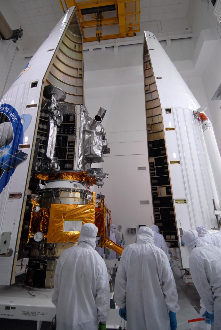 CAPE CANAVERAL, Fla. – At Astrotech Space Operations Facility in Titusville, Fla., technicians closely watch as the fairing halves come together around NASA's Lunar Reconnaissance Orbiter, or LRO, and and NASA's Lunar Crater Observation and Sensing Satellite, known as LCROSS. The fairing is a molded structure that fits flush with the outside surface of the rocket and forms an aerodynamically smooth nose cone, protecting the spacecraft during launch and ascent.The LRO includes five instruments:  DIVINER, LAMP, LEND, LOLA and LROC.  They will be launched aboard an Atlas V/Centaur rocket no earlier than June 17 from Launch Complex-41 on Cape Canaveral Air Force Station in Florida.  Photo credit: NASA/Jack Pfaller