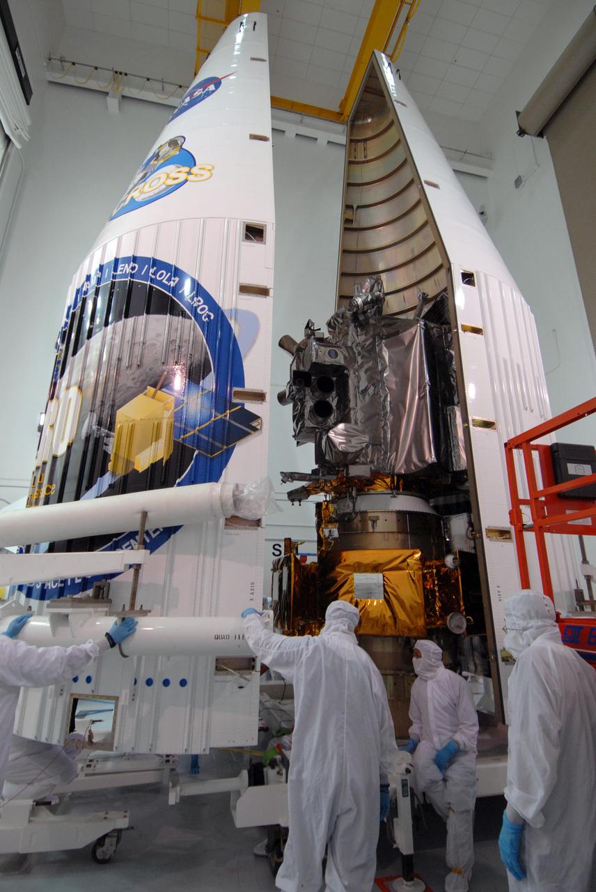 CAPE CANAVERAL, Fla. – At Astrotech Space Operations Facility in Titusville, Fla., the fairing halves are moved together for another attempt at installation around NASA's Lunar Reconnaissance Orbiter, or LRO, and NASA's Lunar Crater Observation and Sensing Satellite, known as LCROSS.  The fairing is a molded structure that fits flush with the outside surface of the rocket and forms an aerodynamically smooth nose cone, protecting the spacecraft during launch and ascent. The LRO includes five instruments:  DIVINER, LAMP, LEND, LOLA and LROC.  They will be launched aboard an Atlas V/Centaur rocket no earlier than June 17 from Launch Complex-41 on Cape Canaveral Air Force Station in Florida.  Photo credit: NASA/Jack Pfaller