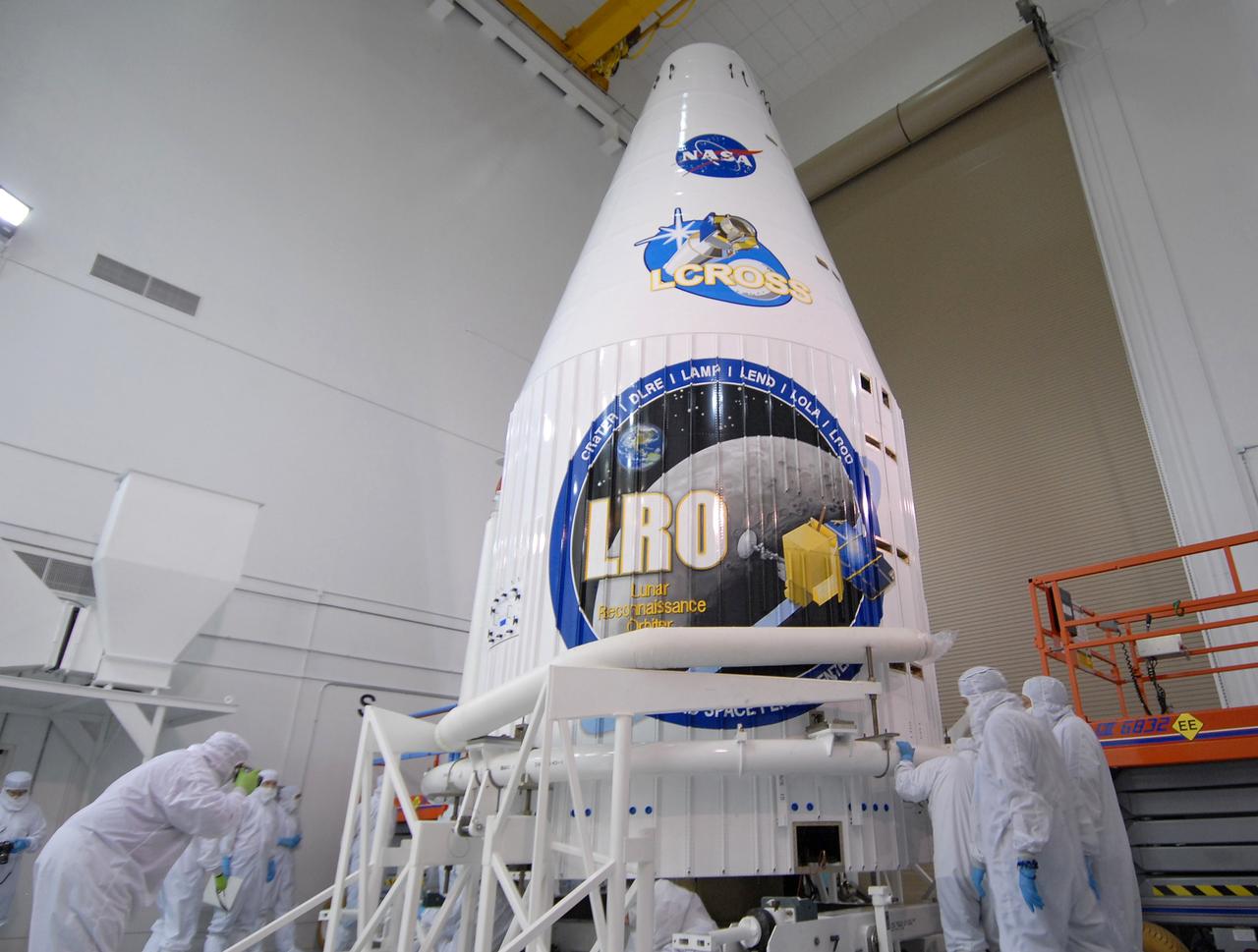 CAPE CANAVERAL, Fla. – At Astrotech Space Operations Facility in Titusville, Fla., the fairing halves have been joined to enclose NASA's Lunar Reconnaissance Orbiter, or LRO, and NASA's Lunar Crater Observation and Sensing Satellite, known as LCROSS.  The fairing is a molded structure that fits flush with the outside surface of the rocket and forms an aerodynamically smooth nose cone, protecting the spacecraft during launch and ascent. The LRO includes five instruments:  DIVINER, LAMP, LEND, LOLA and LROC.  They will be launched aboard an Atlas V/Centaur rocket no earlier than June 17 from Launch Complex-41 on Cape Canaveral Air Force Station in Florida.  Photo credit: NASA/Jack Pfaller
