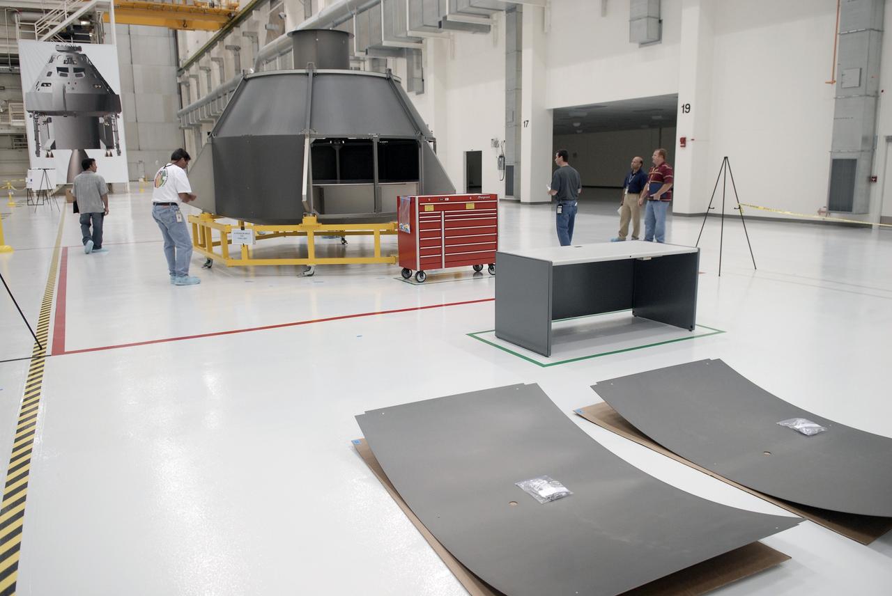 CAPE CANAVERAL, Fla. – In the Operations and Checkout Building's high bay, technicians begin testing how to put the "skins" on the outer mold of the simulator Orion crew module.Part of NASA's Constellation Program, the Orion spacecraft will return humans to the moon and prepare for future voyages to Mars and other destinations in our solar system. Orion is targeted to begin carrying humans to the International Space Station in 2015 and to the moon by 2020. Photo credit: NASA/Kim Shiflett