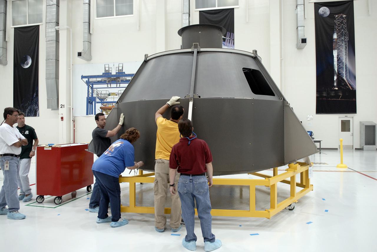 CAPE CANAVERAL, Fla. – In the Operations and Checkout Building's high bay, technicians test how to put the "skins" on the outer mold of the simulator Orion crew module. Part of NASA's Constellation Program, the Orion spacecraft will return humans to the moon and prepare for future voyages to Mars and other destinations in our solar system. Orion is targeted to begin carrying humans to the International Space Station in 2015 and to the moon by 2020.  Photo credit: NASA/Kim Shiflett