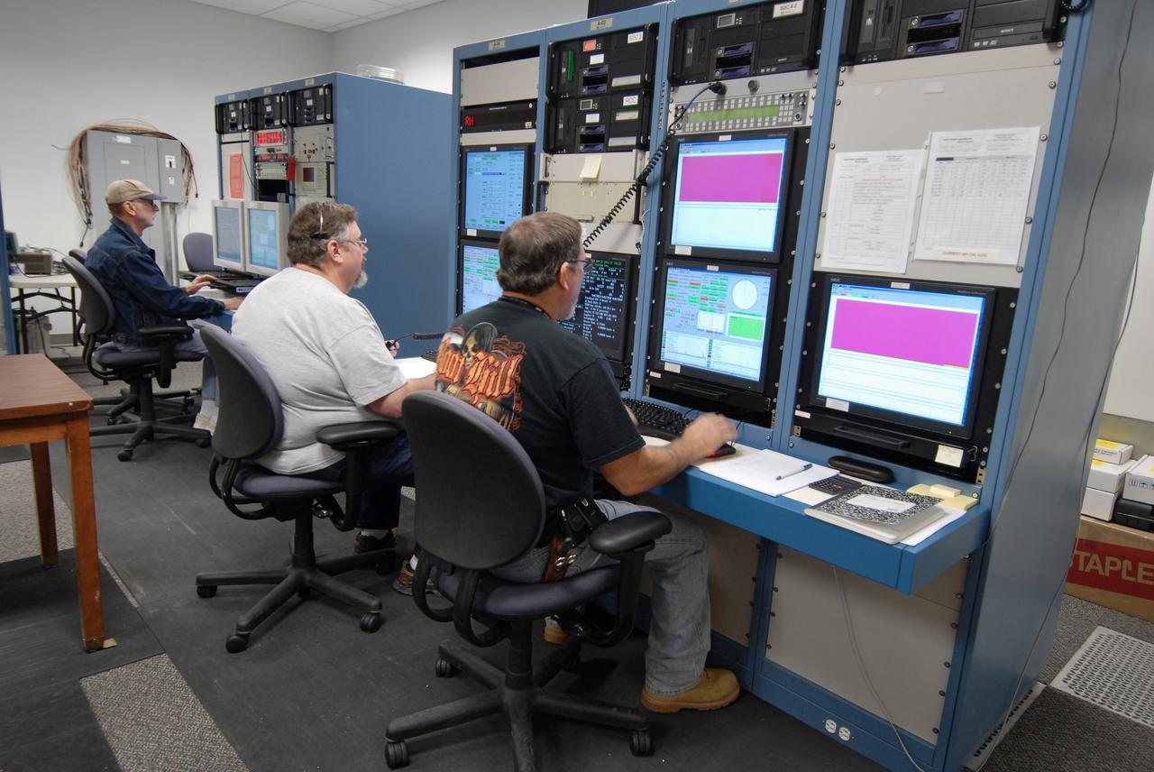 CAPE CANAVERAL, Fla. – Technicians work the console collecting data from NASA's C-band Debris Radar antenna at a site on North Merritt Island in Florida.  One of the largest of its kind in the world, the C-band radar provided critical support to pinpoint debris during the launch of space shuttle Atlantis on the STS-125 mission. The need for this radar was identified after the Columbia tragedy.  It worked together with smaller X-band radars placed on the solid rocket booster ship Liberty Star and the U.S. Army landing craft utility ship Brandy Station.  Together they provided extremely high resolution images of any debris that created by Atlantis during launch.  Photo credit: NASA/Troy Cryder