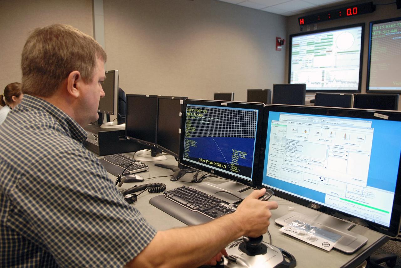 CAPE CANAVERAL, Fla. – An engineer analyzes data from NASA's C-band Debris Radar antenna at a site on North Merritt Island in Florida.  One of the largest of its kind in the world, the C-band radar provided critical support to pinpoint debris during the launch of space shuttle Atlantis on the STS-125 mission. The need for this radar was identified after the Columbia tragedy.  It worked together with smaller X-band radars placed on the solid rocket booster ship Liberty Star and the U.S. Army landing craft utility ship Brandy Station.  Together they provided extremely high resolution images of any debris that created by Atlantis during launch.  Photo credit: NASA/Troy Cryder