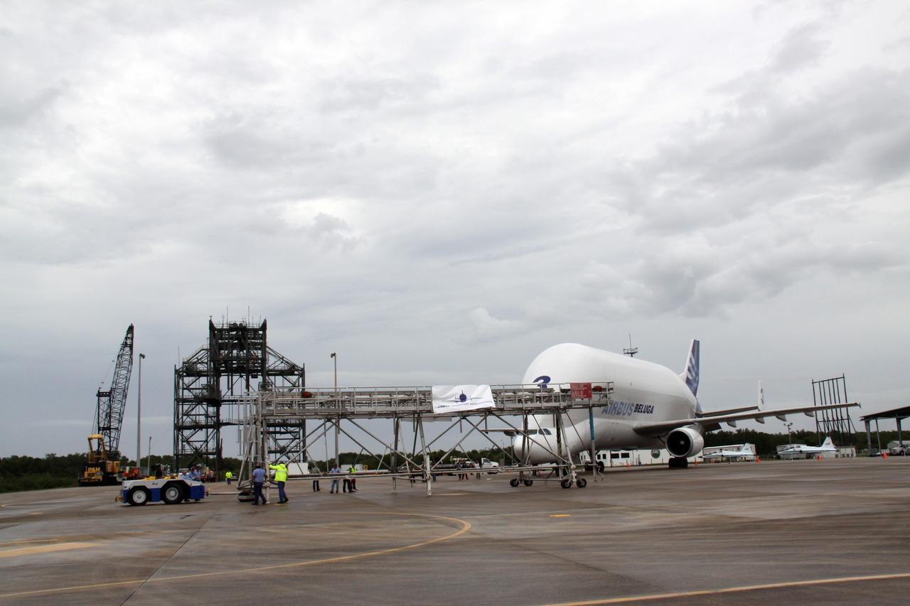 CAPE CANAVERAL, Fla. – On the Shuttle landing Facility at NASA's Kennedy Space Center in Florida, workers move equipment toward the Beluga Airbus for the offloading of the Node 3 module. Named Tranquility, the module will be delivered to the International Space Station on the STS-130 mission.  Tranquility will eventually house the life support equipment necessary for the space station's permanent crew of six. It will also accommodate the European Space Agency's Cupola observation module, a seven-window, dome-shaped structure.  Tranquility is targeted for launch aboard space shuttle Endeavour in February 2010.  Photo credit: NASA/Jack Pfaller