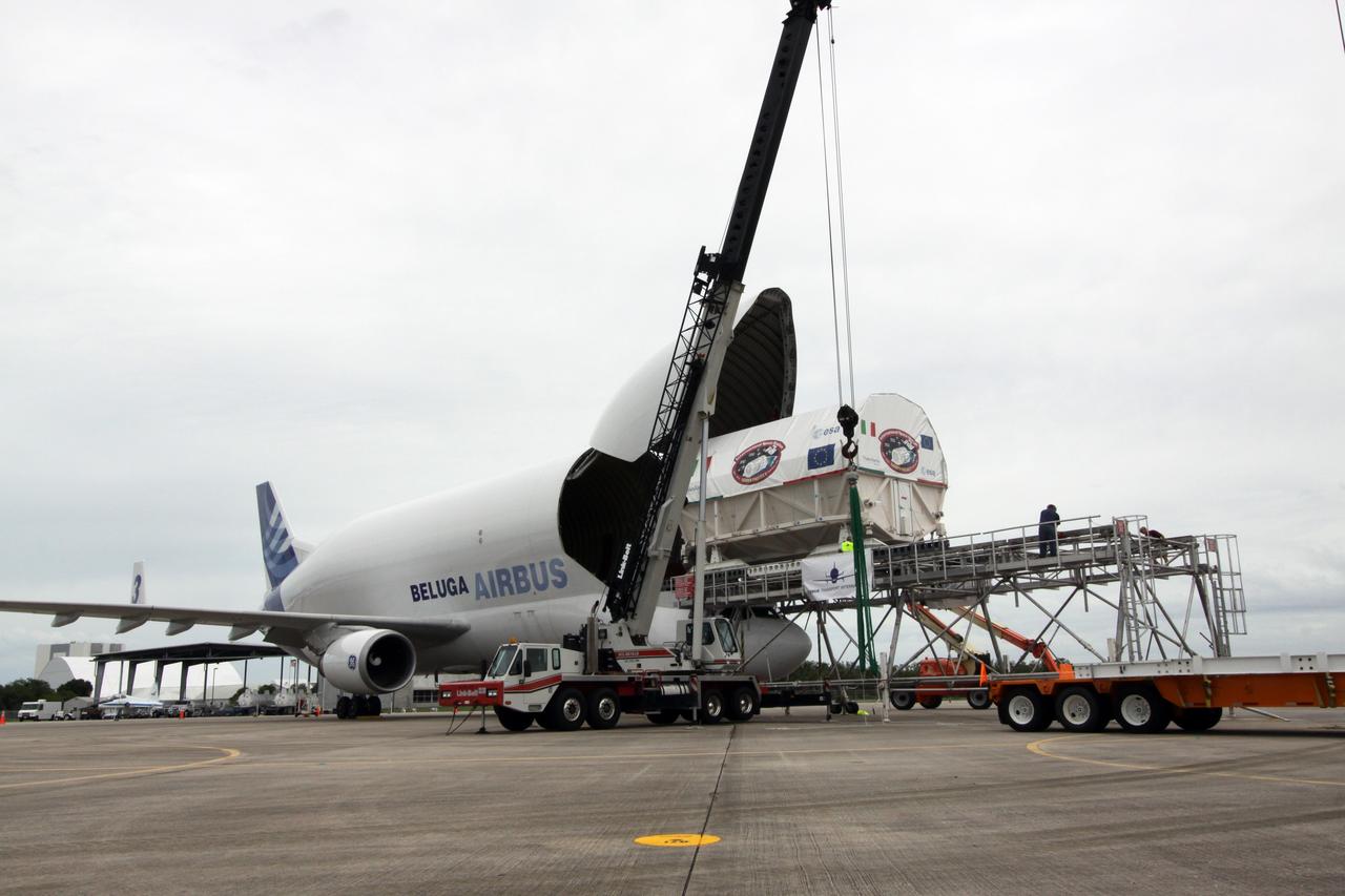 CAPE CANAVERAL, Fla. – On the Shuttle Landing Facility at NASA's Kennedy Space Center in Florida, a crane is ready to be attached to the Node 3 module when it moves clear of the Beluga Airbus.  The crane will lift the module onto a flatbed for transport to the Space Station Processing Facility.  Named Tranquility, the module will be delivered to the International Space Station on the STS-130 mission. Tranquility will eventually house the life support equipment necessary for the space station's permanent crew of six. It will also accommodate the European Space Agency's Cupola observation module, a seven-window, dome-shaped structure.  Tranquility is targeted for launch aboard space shuttle Endeavour in February 2010.  Photo credit: NASA/Jack Pfaller