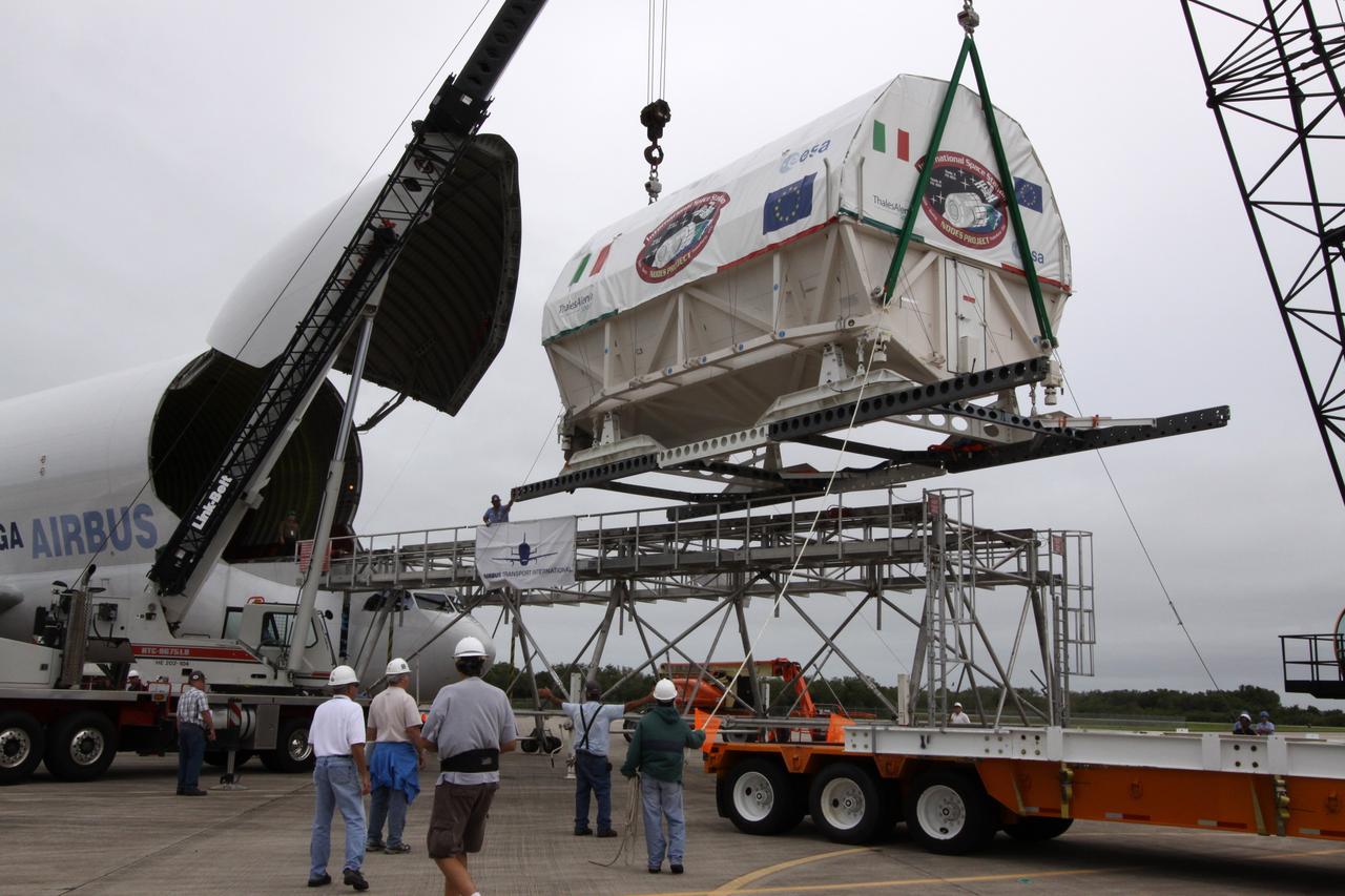 CAPE CANAVERAL, Fla. – On the Shuttle Landing Facility at NASA's Kennedy Space Center in Florida, a crane lifts the Node 3 module toward the flatbed that will transport it to the Space Station Processing Facility. Named Tranquility, the module will be delivered to the International Space Station on the STS-130 mission. Tranquility will eventually house the life support equipment necessary for the space station's permanent crew of six. It will also accommodate the European Space Agency's Cupola observation module, a seven-window, dome-shaped structure. Tranquility is targeted for launch aboard space shuttle Endeavour in February 2010. Photo credit: NASA/Jack Pfaller